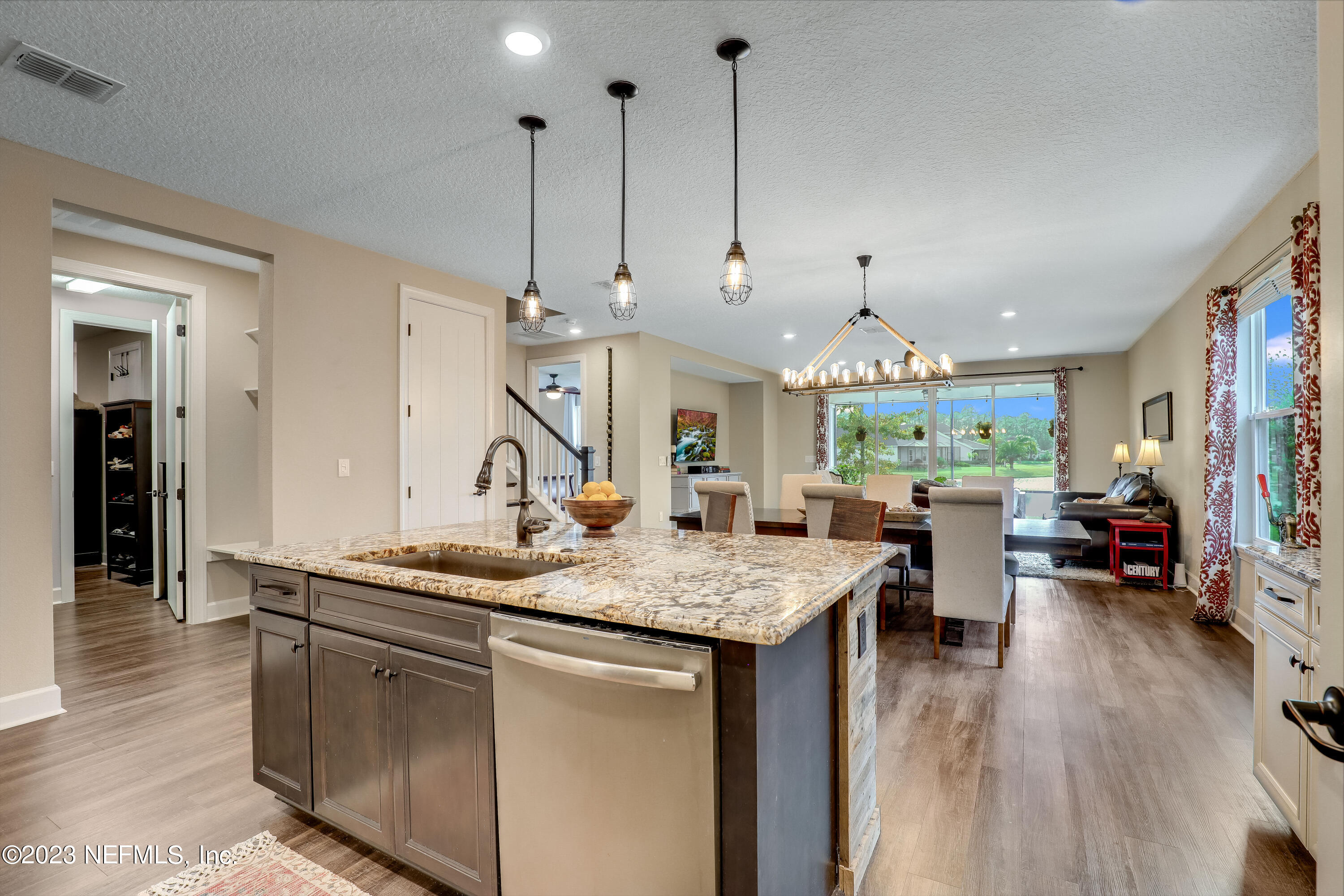 85248 Champlain Drive Fernandina Beach, FL 32034 - Photo 16 of 79 a open kitchen with stainless steel appliances granite countertop a sink a stove and a wooden floors