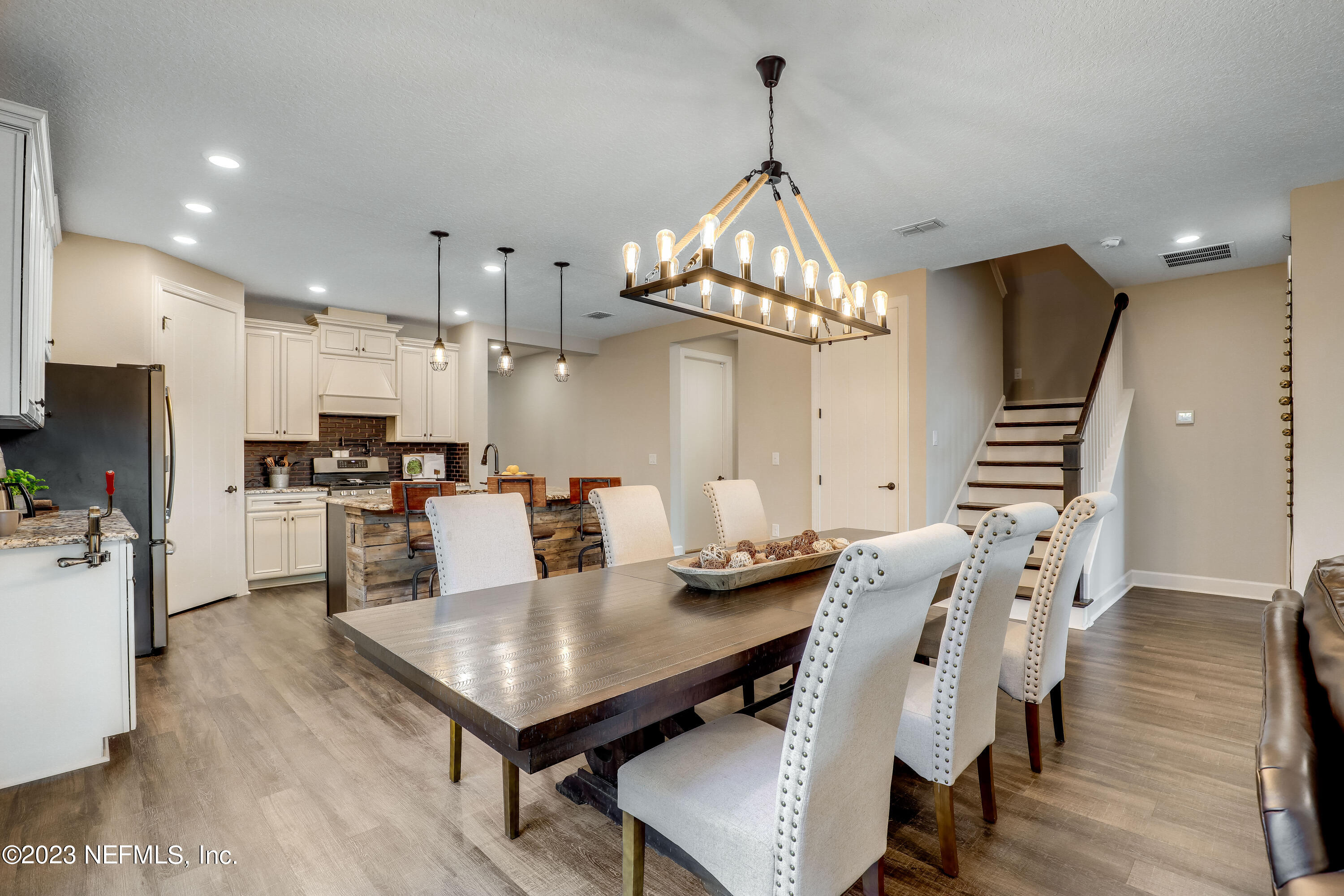 85248 Champlain Drive Fernandina Beach, FL 32034 - Photo 19 of 79 a view of a dining room and livingroom with furniture wooden floor a chandelier