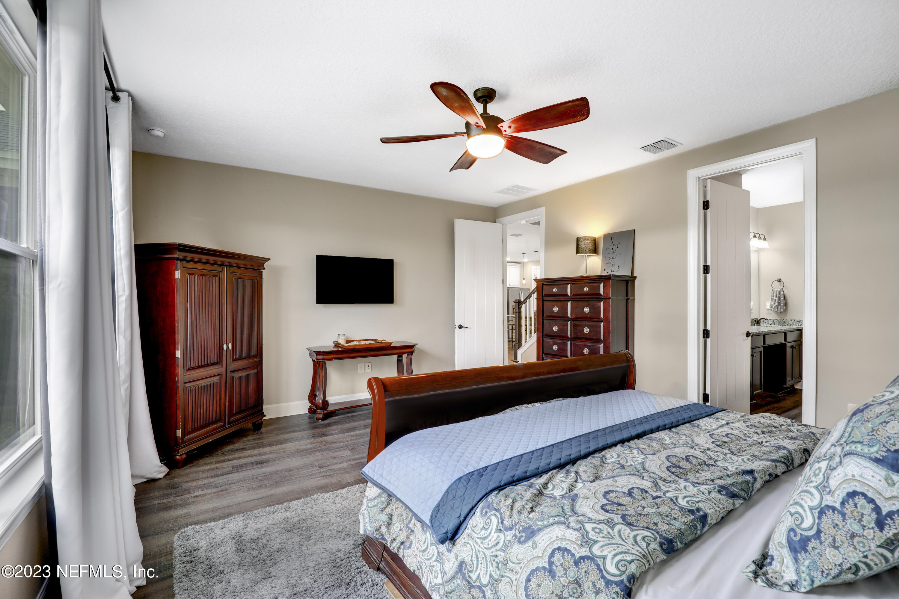 85248 Champlain Drive Fernandina Beach, FL 32034 - Photo 25 of 79 a bedroom with a bed and a flat screen tv