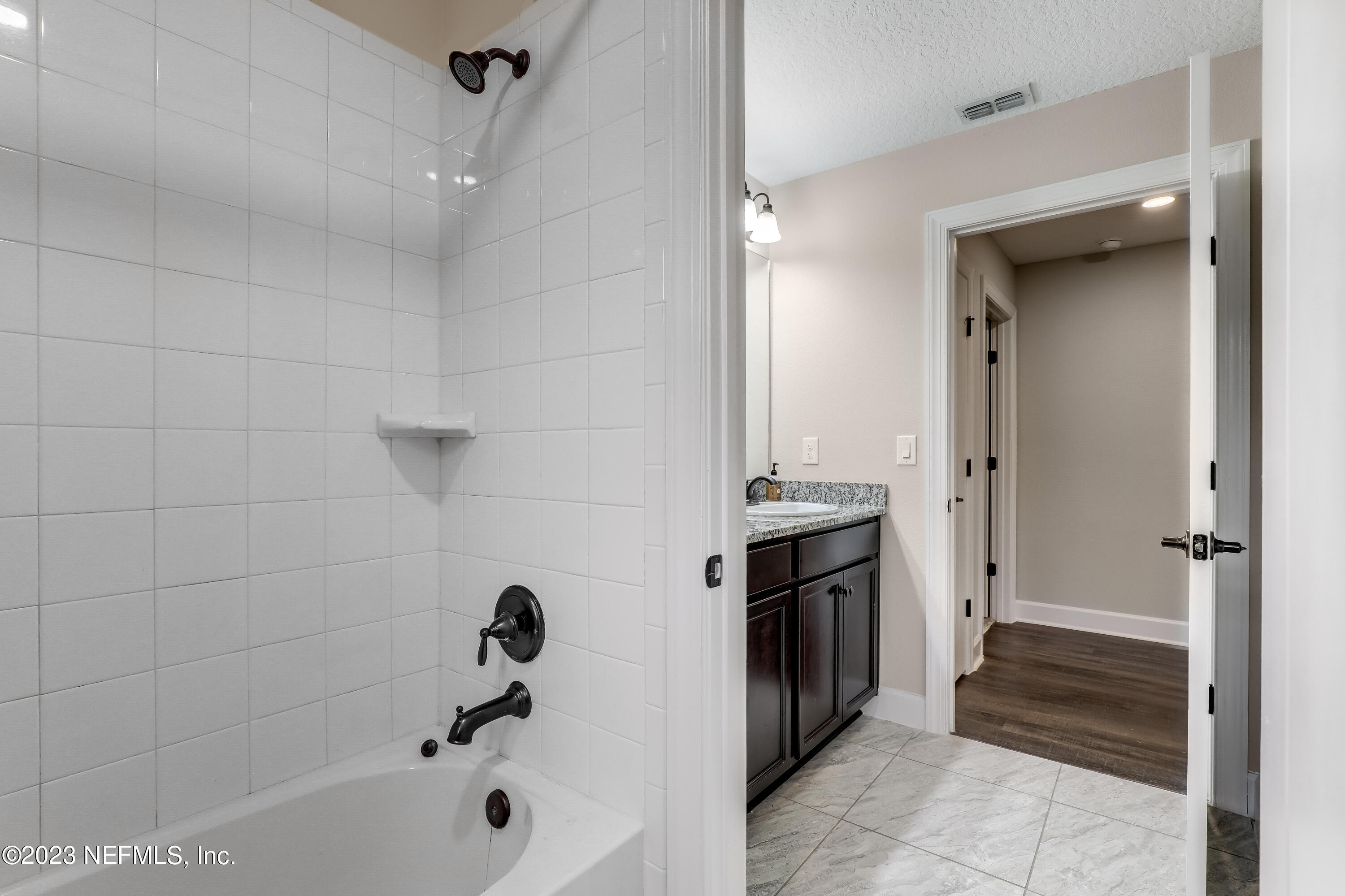 85248 Champlain Drive Fernandina Beach, FL 32034 - Photo 32 of 79 a bathroom with a tub a sink and a shower