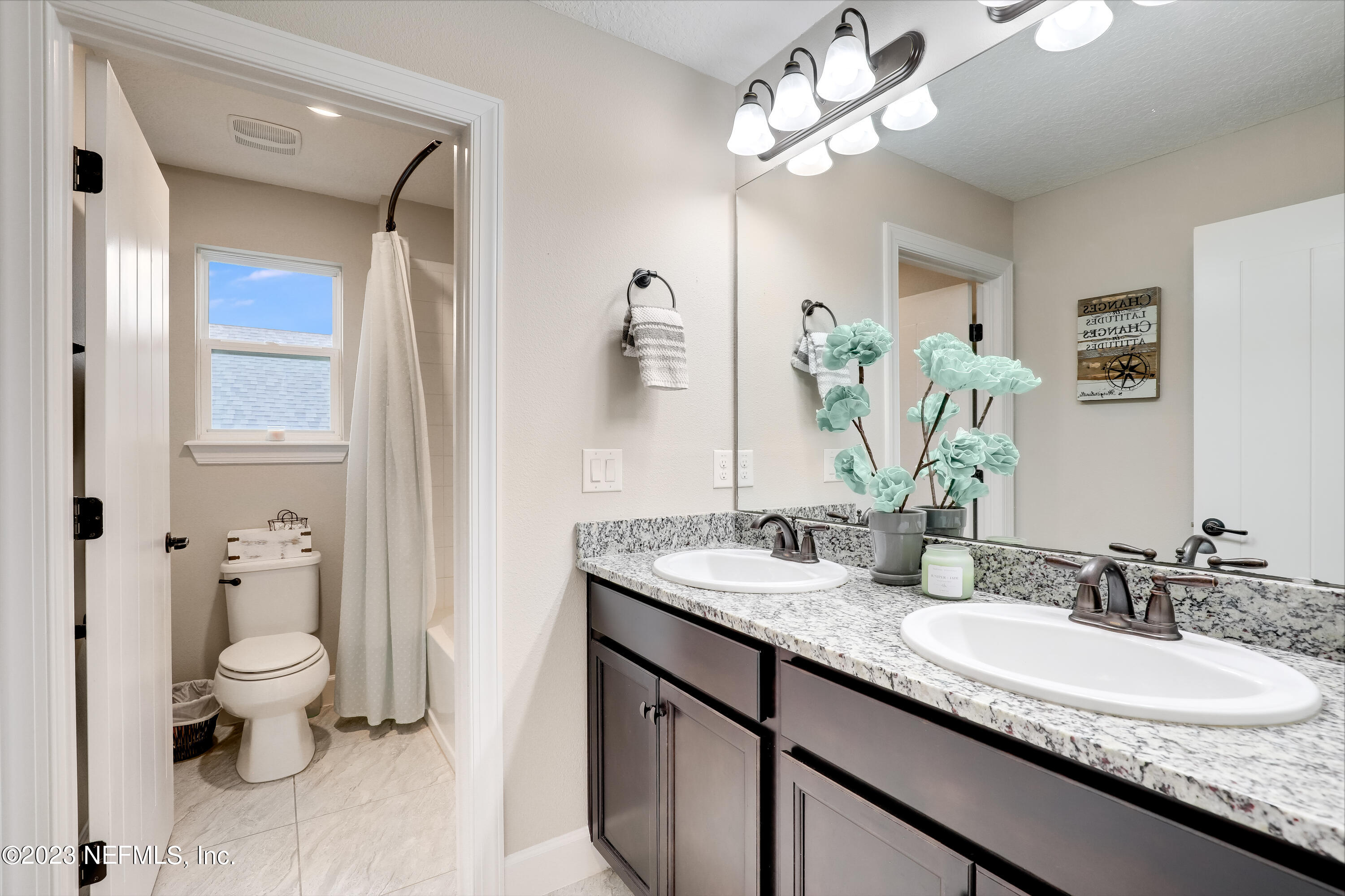 85248 Champlain Drive Fernandina Beach, FL 32034 - Photo 33 of 79 a bathroom with a granite countertop double vanity sink a mirror and a toilet