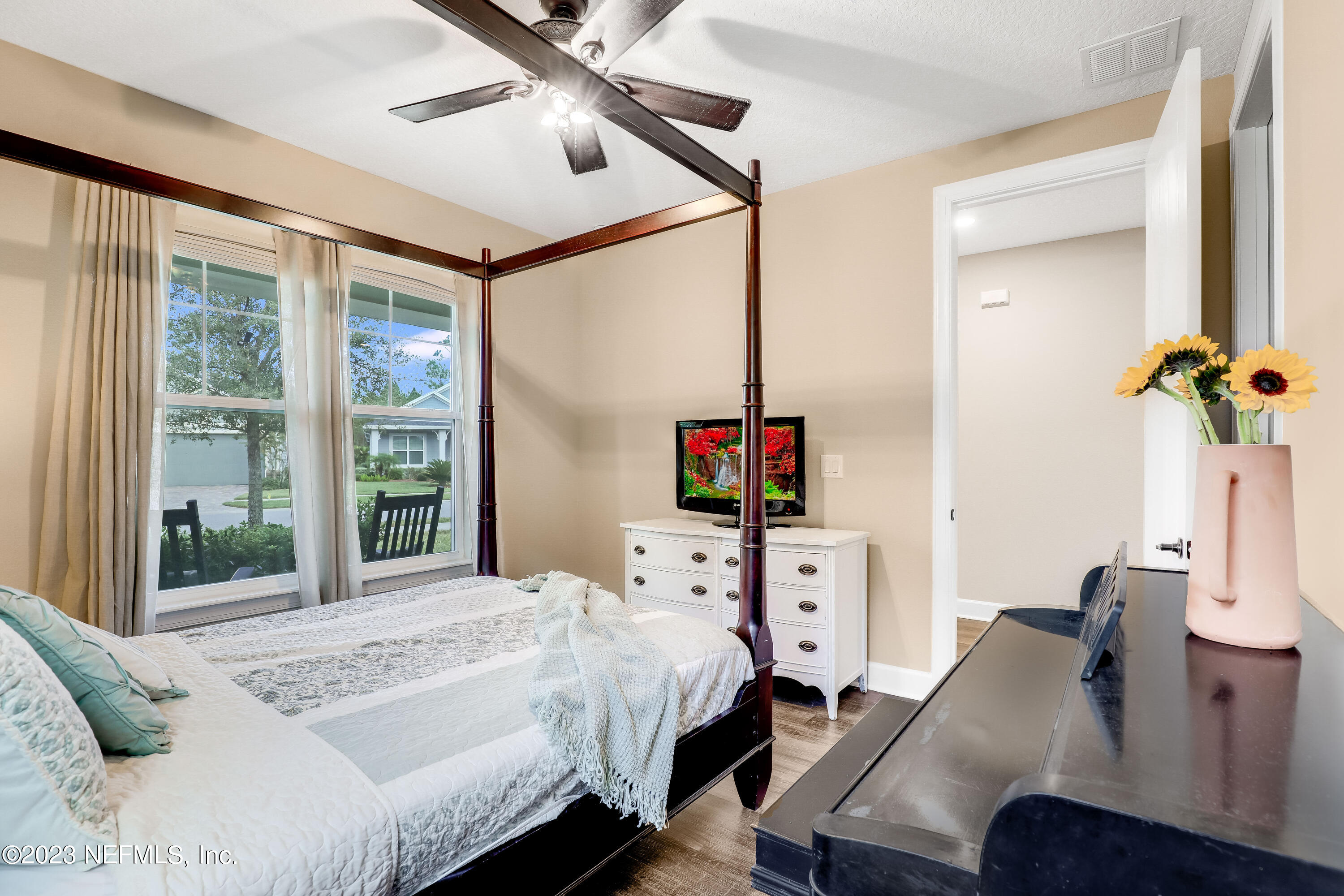 85248 Champlain Drive Fernandina Beach, FL 32034 - Photo 35 of 79 a bedroom with a bed and a flat screen tv