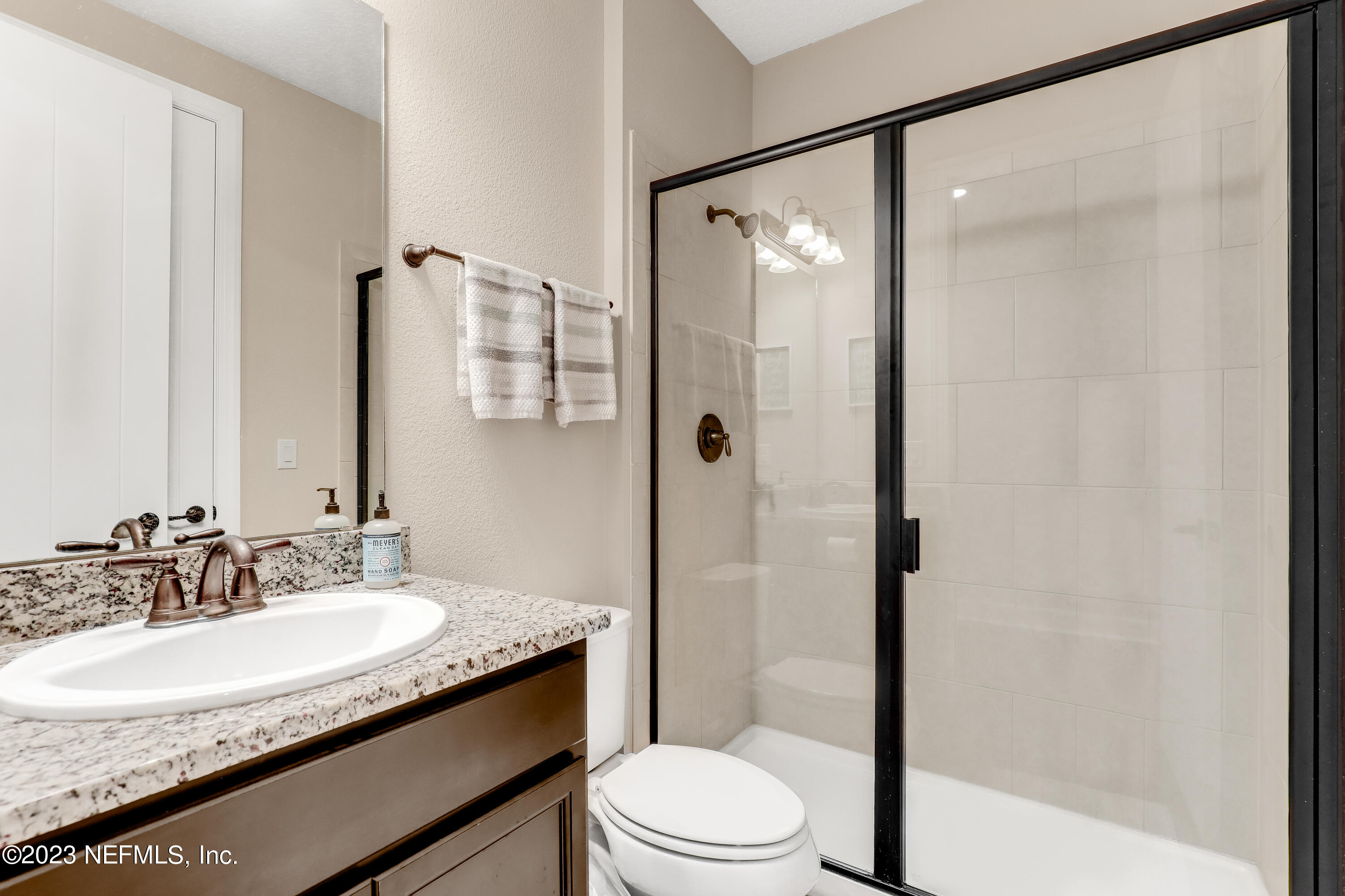 85248 Champlain Drive Fernandina Beach, FL 32034 - Photo 37 of 79 a bathroom with a granite countertop sink toilet and shower