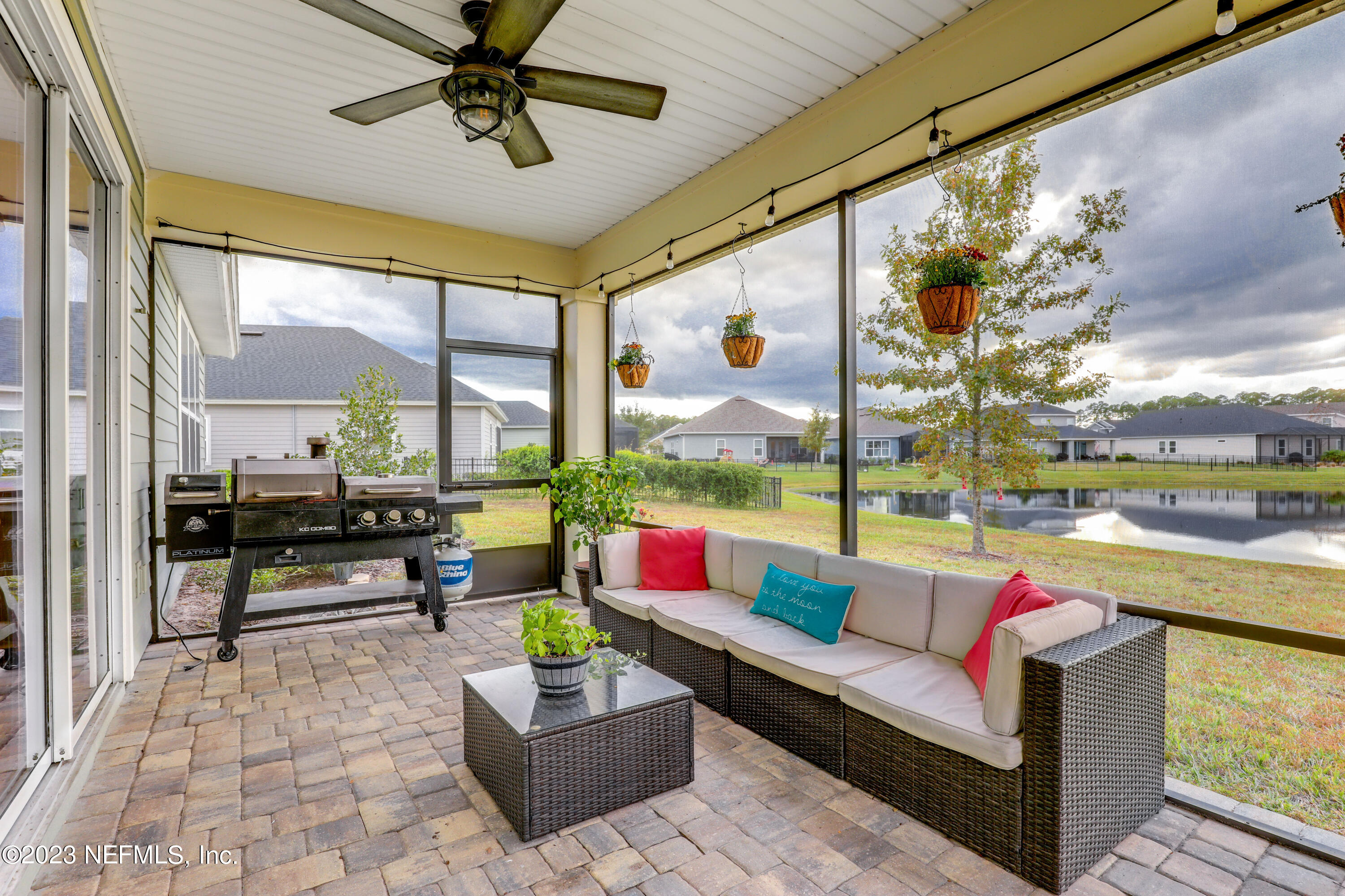 85248 Champlain Drive Fernandina Beach, FL 32034 - Photo 52 of 79 a living room with patio furniture and a floor to ceiling window