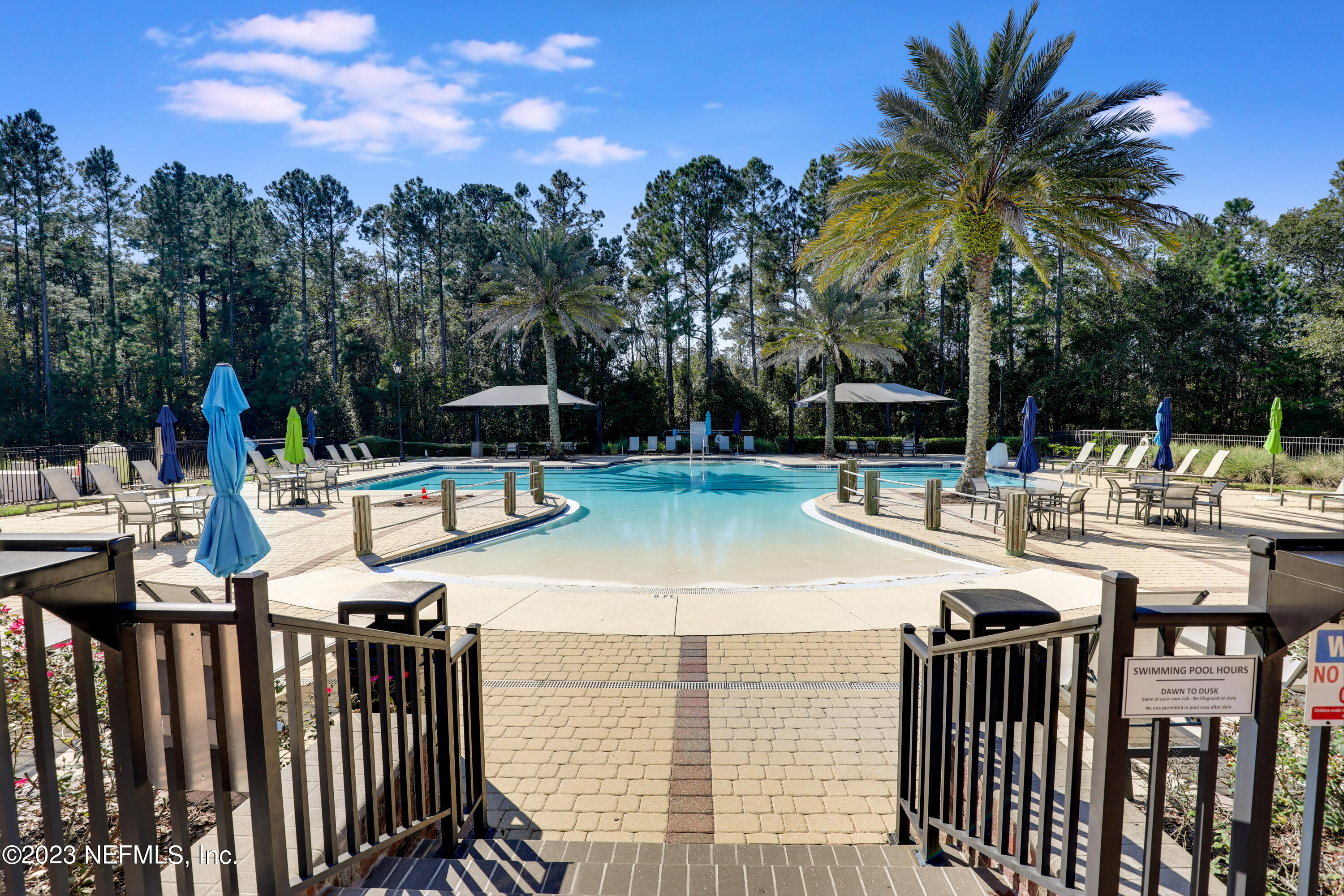 85248 Champlain Drive Fernandina Beach, FL 32034 - Photo 60 of 79 a view of a patio with swimming pool and sitting area