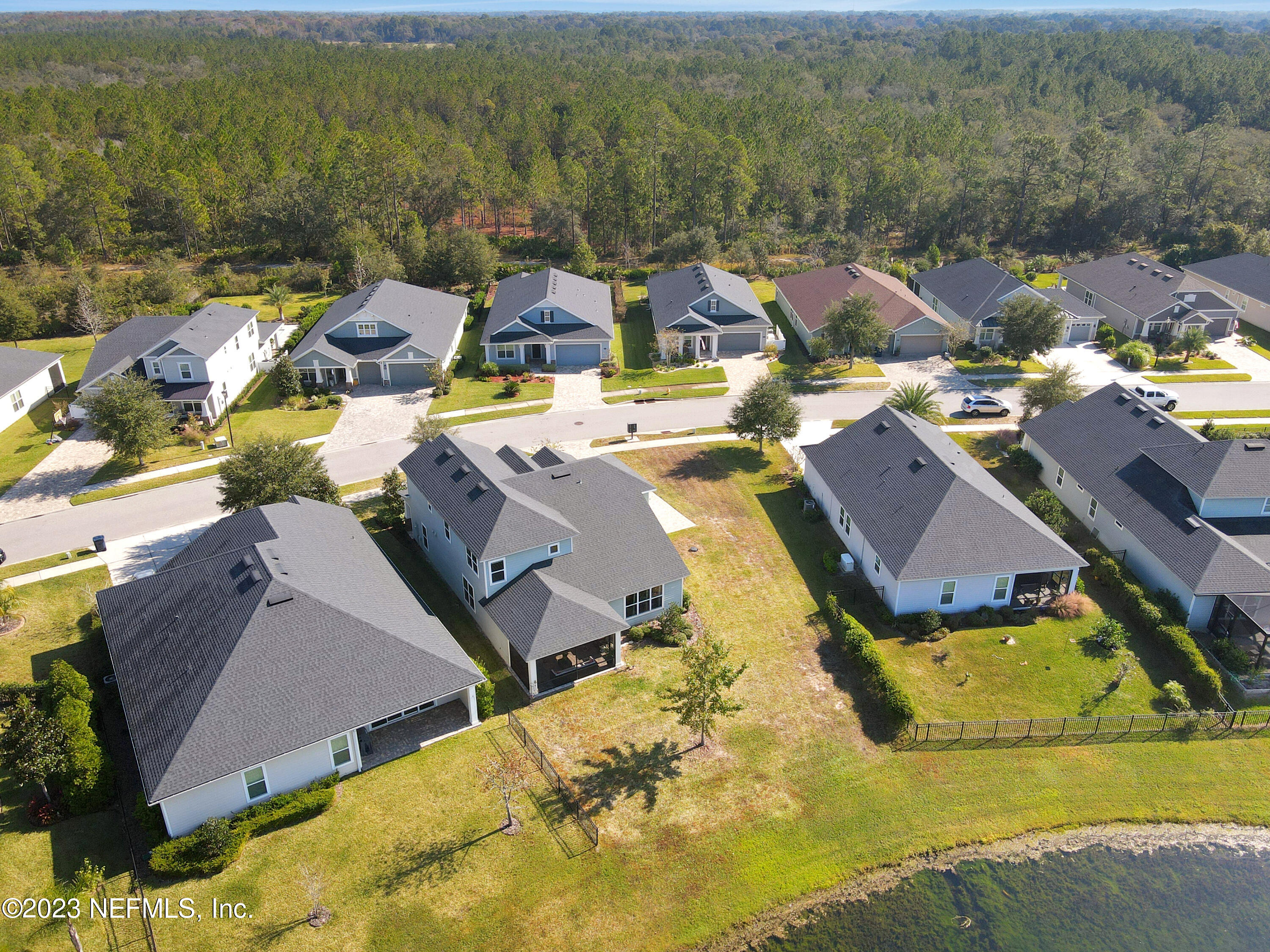 85248 Champlain Drive Fernandina Beach, FL 32034 - Photo 76 of 79 an aerial view of a house with a swimming pool yard and outdoor seating