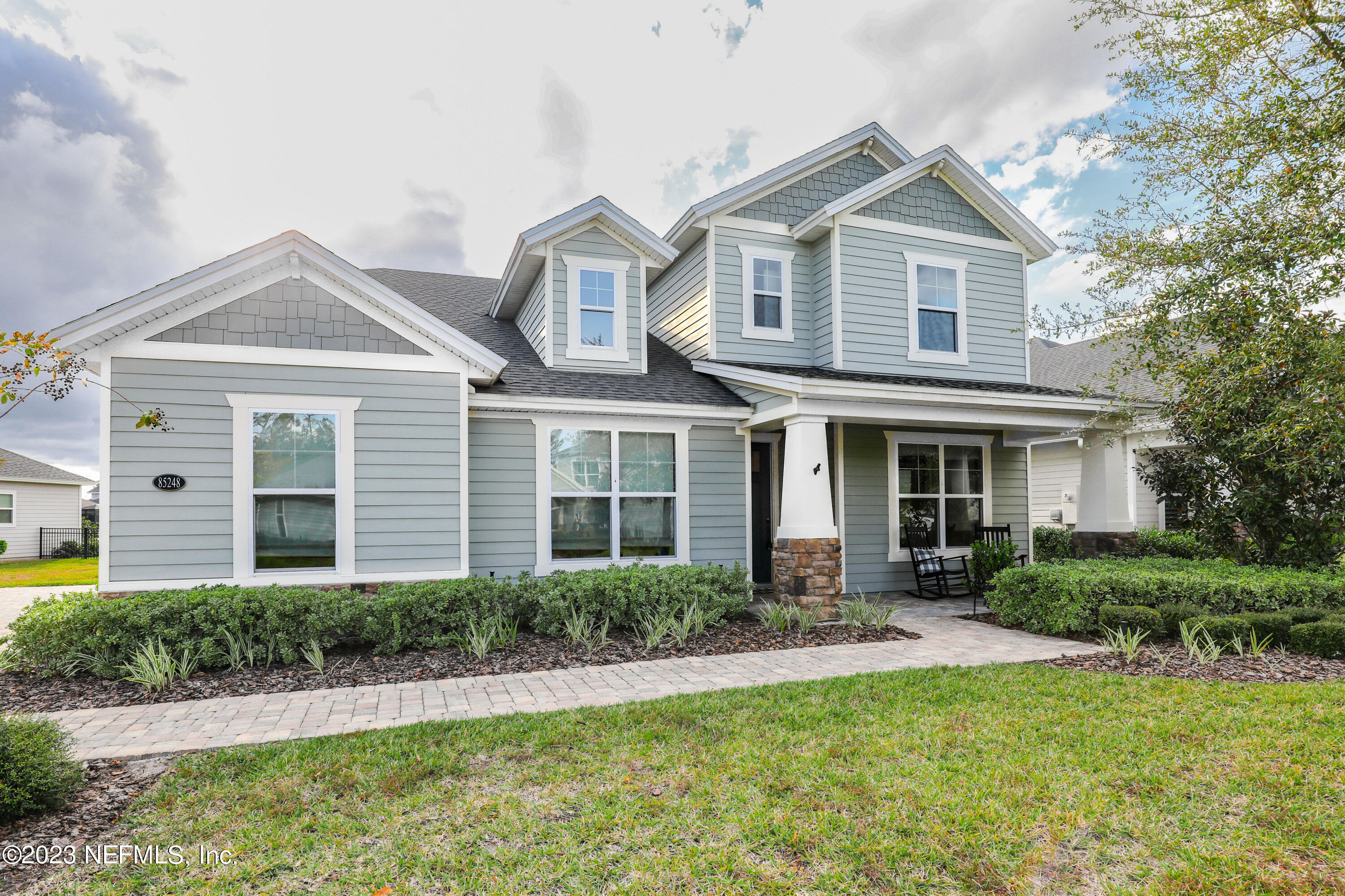 85248 Champlain Drive Fernandina Beach, FL 32034 - Photo 77 of 79 a front view of a house with a yard and porch