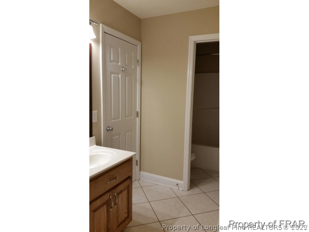 5265 Stewart Road Wade, NC 28395 - Photo 18 of 26 a spacious bathroom with a sink and a mirror