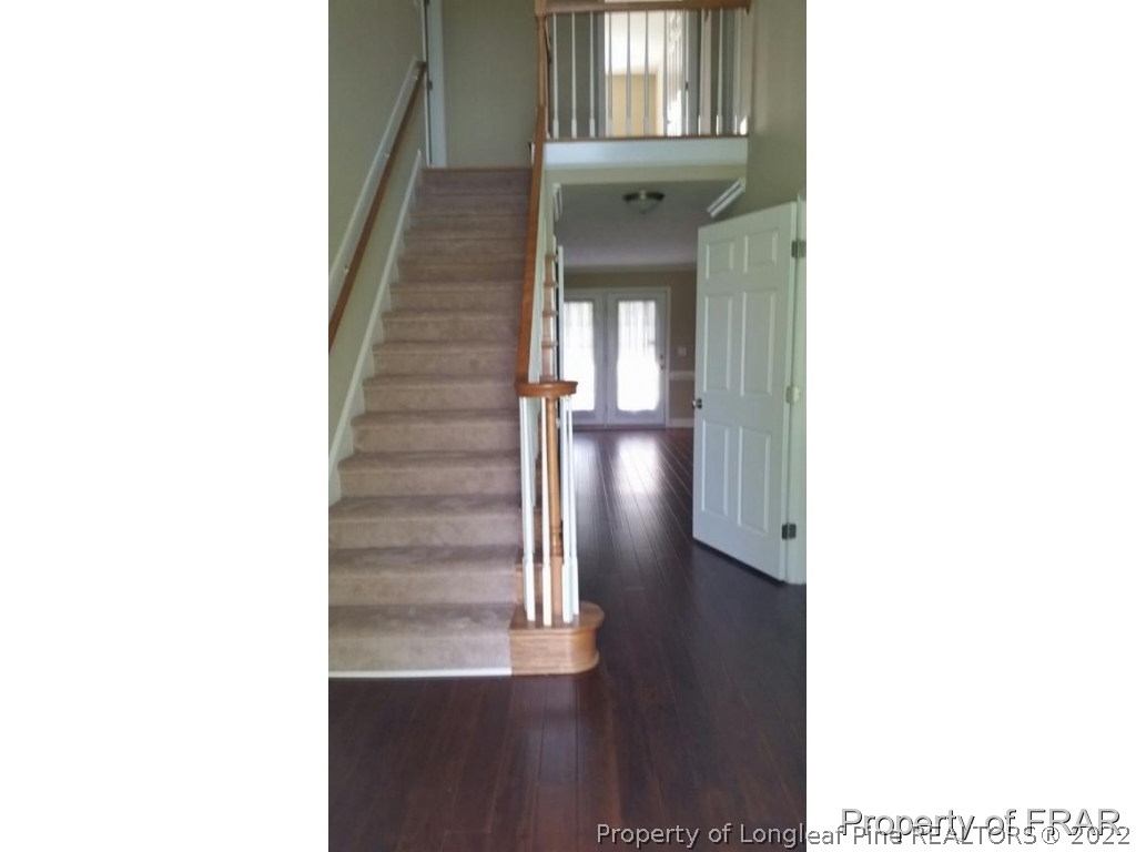 5265 Stewart Road Wade, NC 28395 - Photo 20 of 26 a view of a hallway with front door and stairs