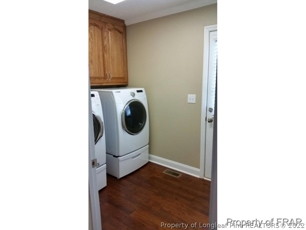 5265 Stewart Road Wade, NC 28395 - Photo 22 of 26 a view of a hallway with washer and dryer