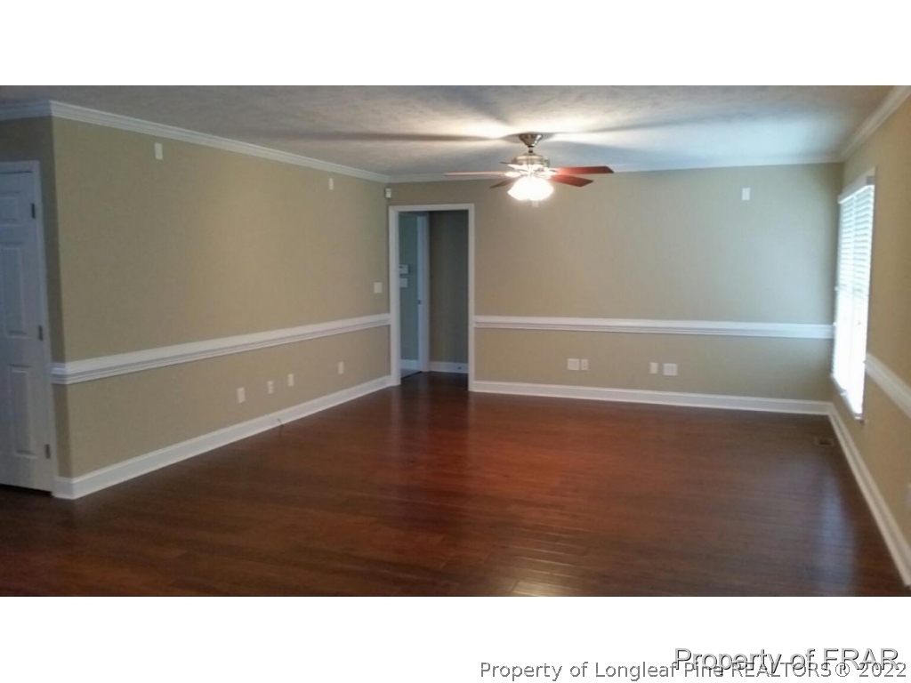 5265 Stewart Road Wade, NC 28395 - Photo 5 of 26 a room with wooden floor and window