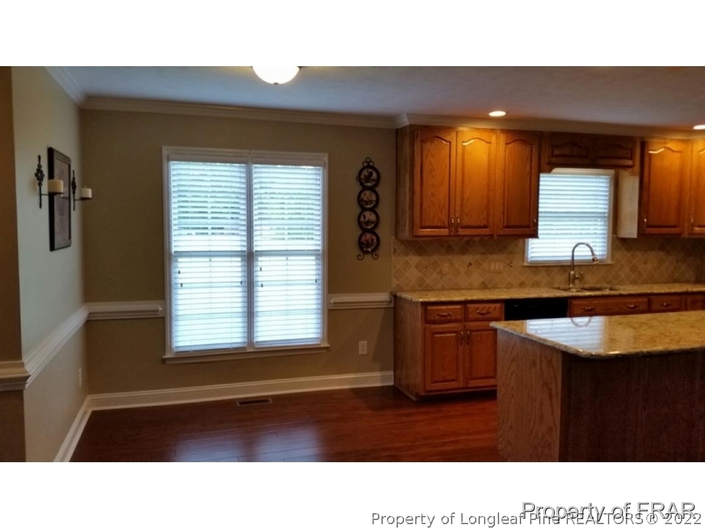 5265 Stewart Road Wade, NC 28395 - Photo 9 of 26 a kitchen with a sink a window and cabinets