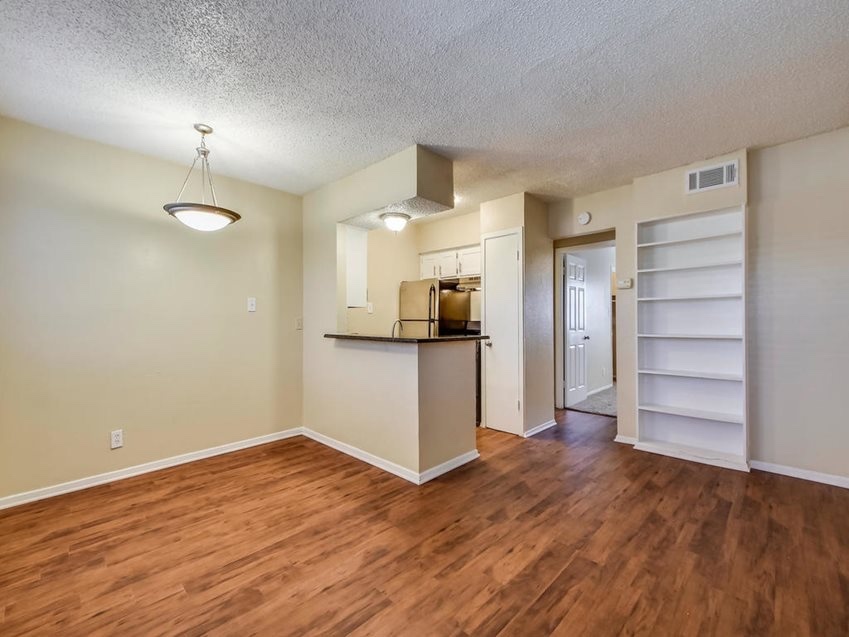 2401 Manor Road, Unit 119 Austin, TX 78722 - Photo 5 of 5 a view of a kitchen with wooden floor and a refrigerator