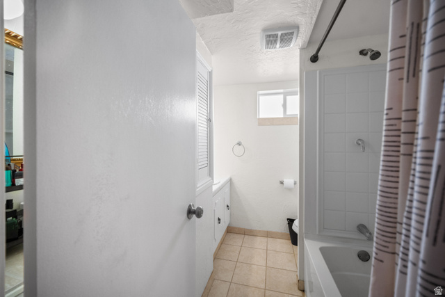 3233 Jean Street Magna, UT 84044 - Photo 20 of 33 Bathroom featuring a white subway tile shower, white built-in cabinetry, and neutral floor tiling