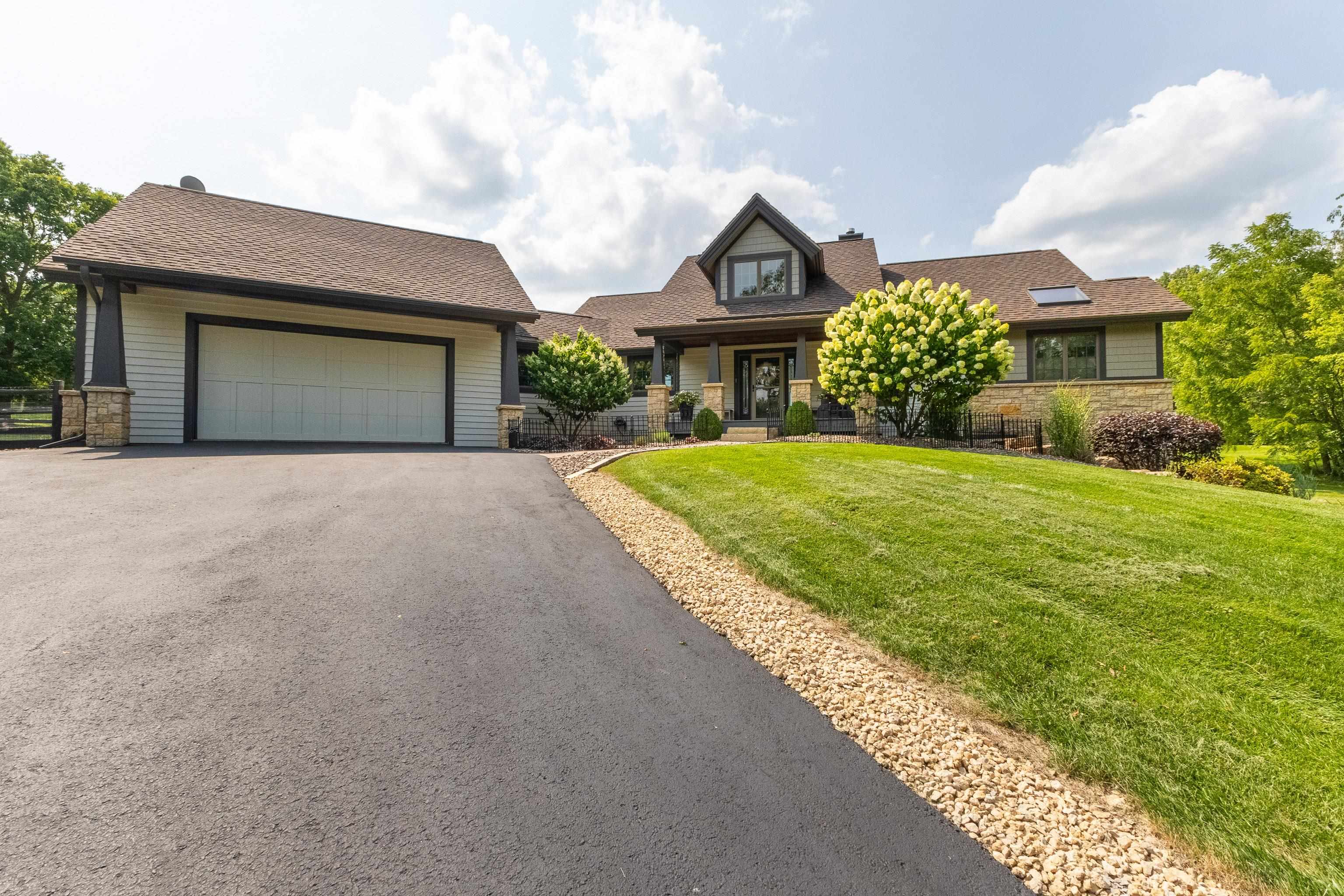 6 Hickory Trail Galena, IL 61036 - Photo 11 of 67 a front view of a house with a yard and garage