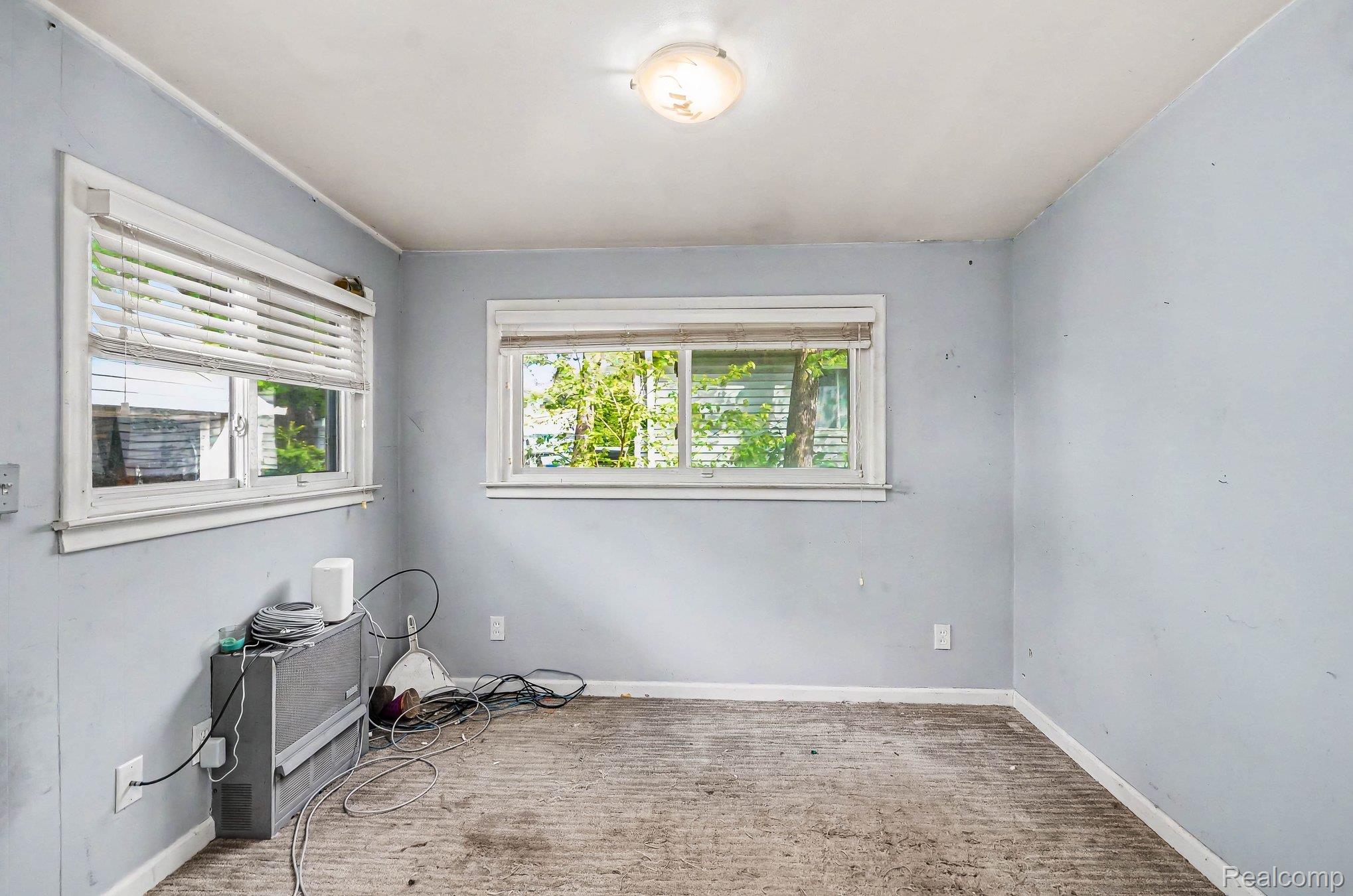 2126 Roslyn Road Grosse Pointe, MI 48236 - Photo 10 of 25 Empty room featuring baseboards and light carpet