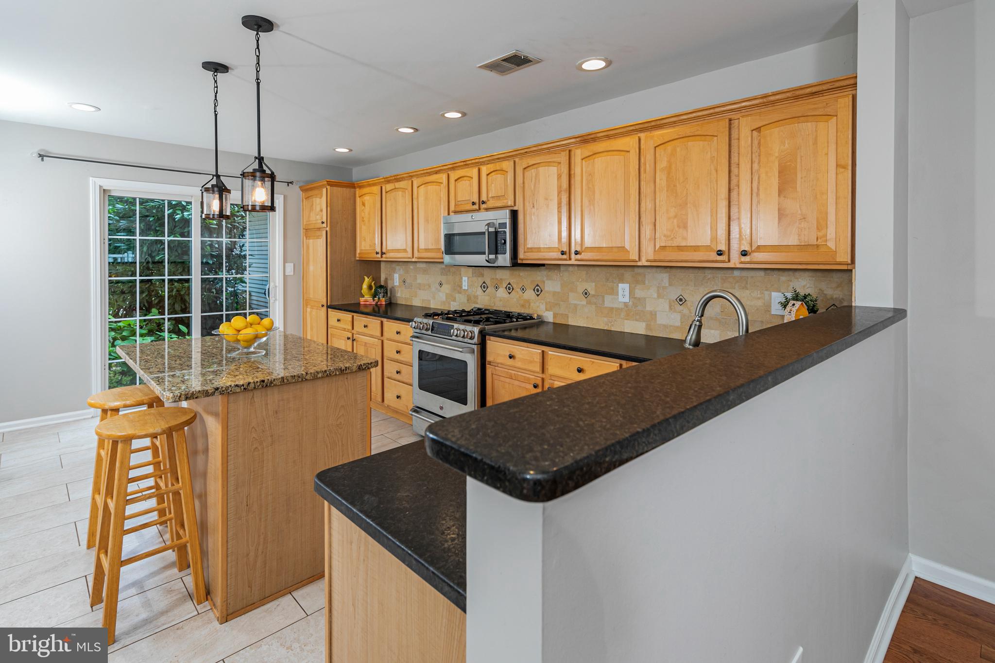 371 Watkins Road Pennington, NJ 08534 - Photo 12 of 42 a kitchen with stainless steel appliances granite countertop a sink a stove and a refrigerator
