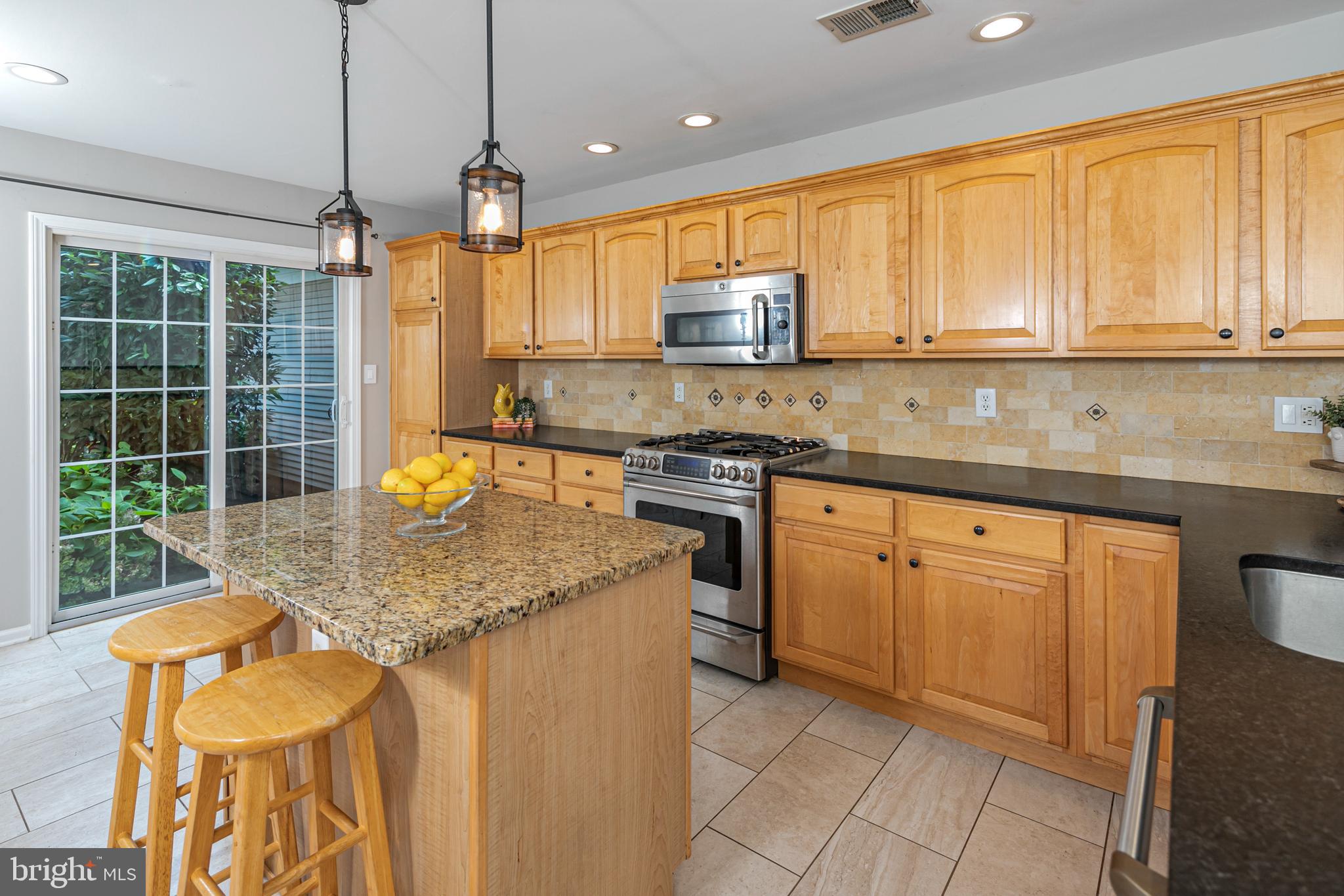 371 Watkins Road Pennington, NJ 08534 - Photo 13 of 42 a kitchen with stainless steel appliances granite countertop a stove a sink and a microwave