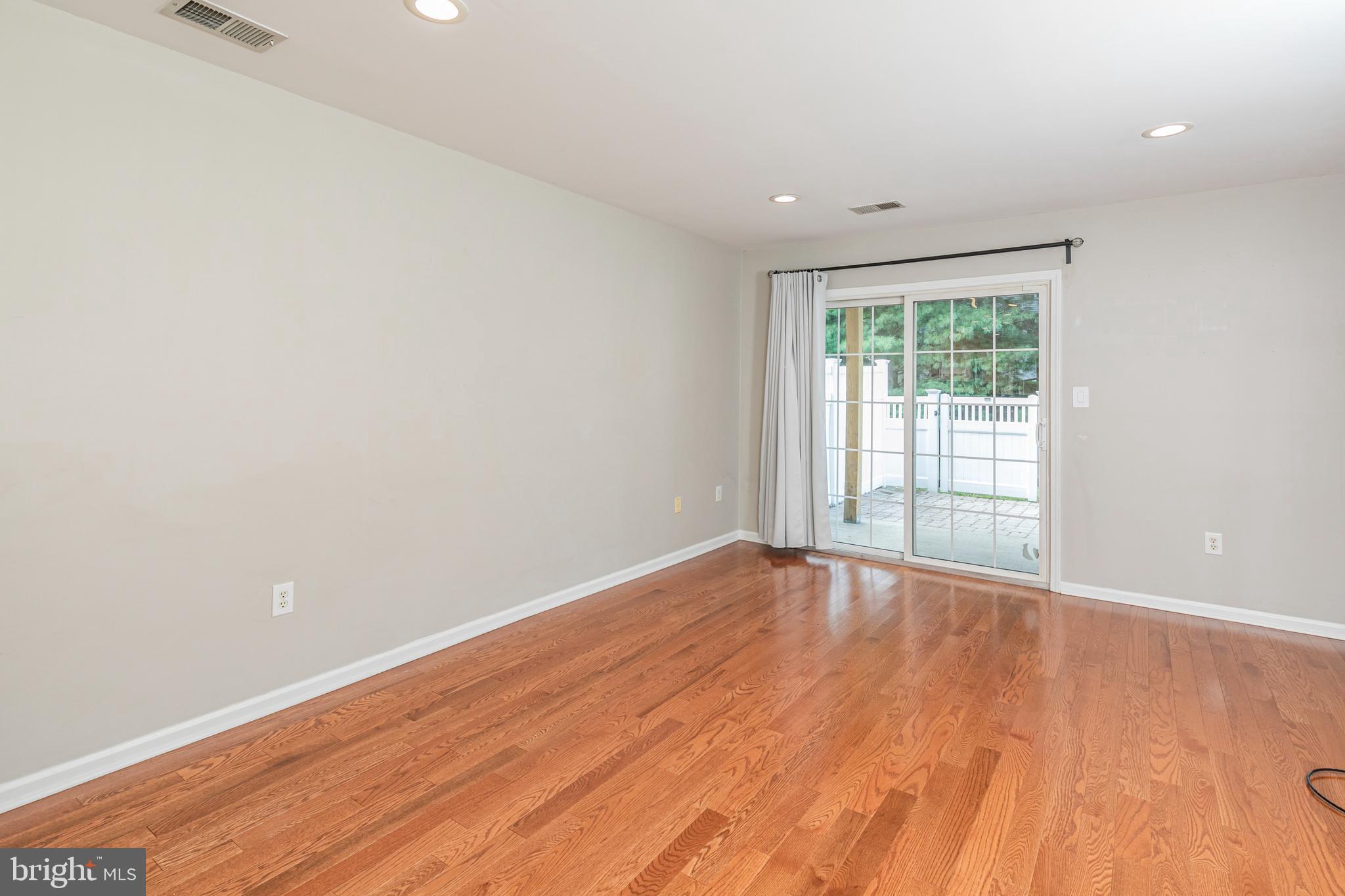 371 Watkins Road Pennington, NJ 08534 - Photo 18 of 42 an empty room with wooden floor and windows