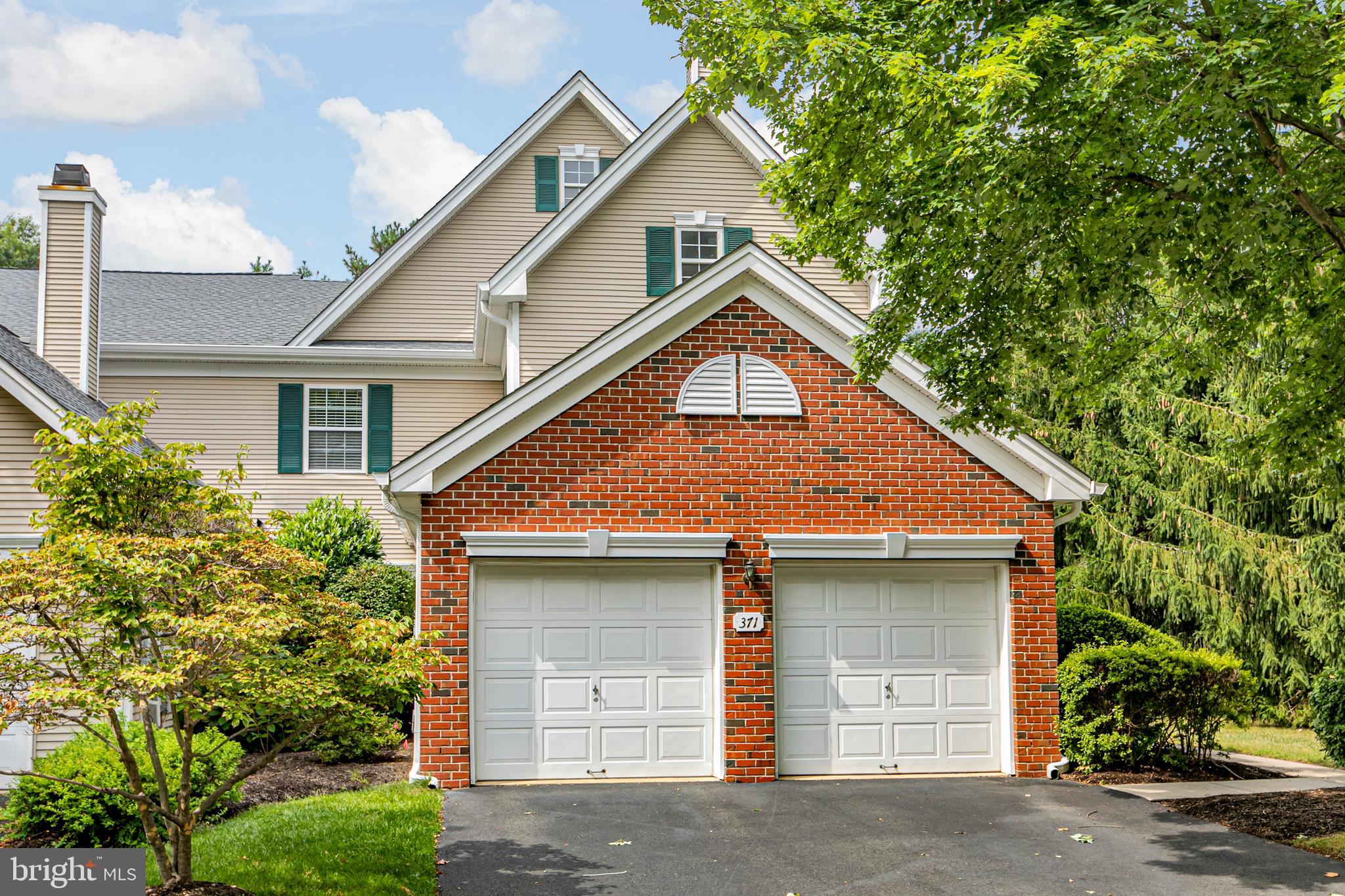 371 Watkins Road Pennington, NJ 08534 - Photo 40 of 42 a front view of a house with a yard and garage