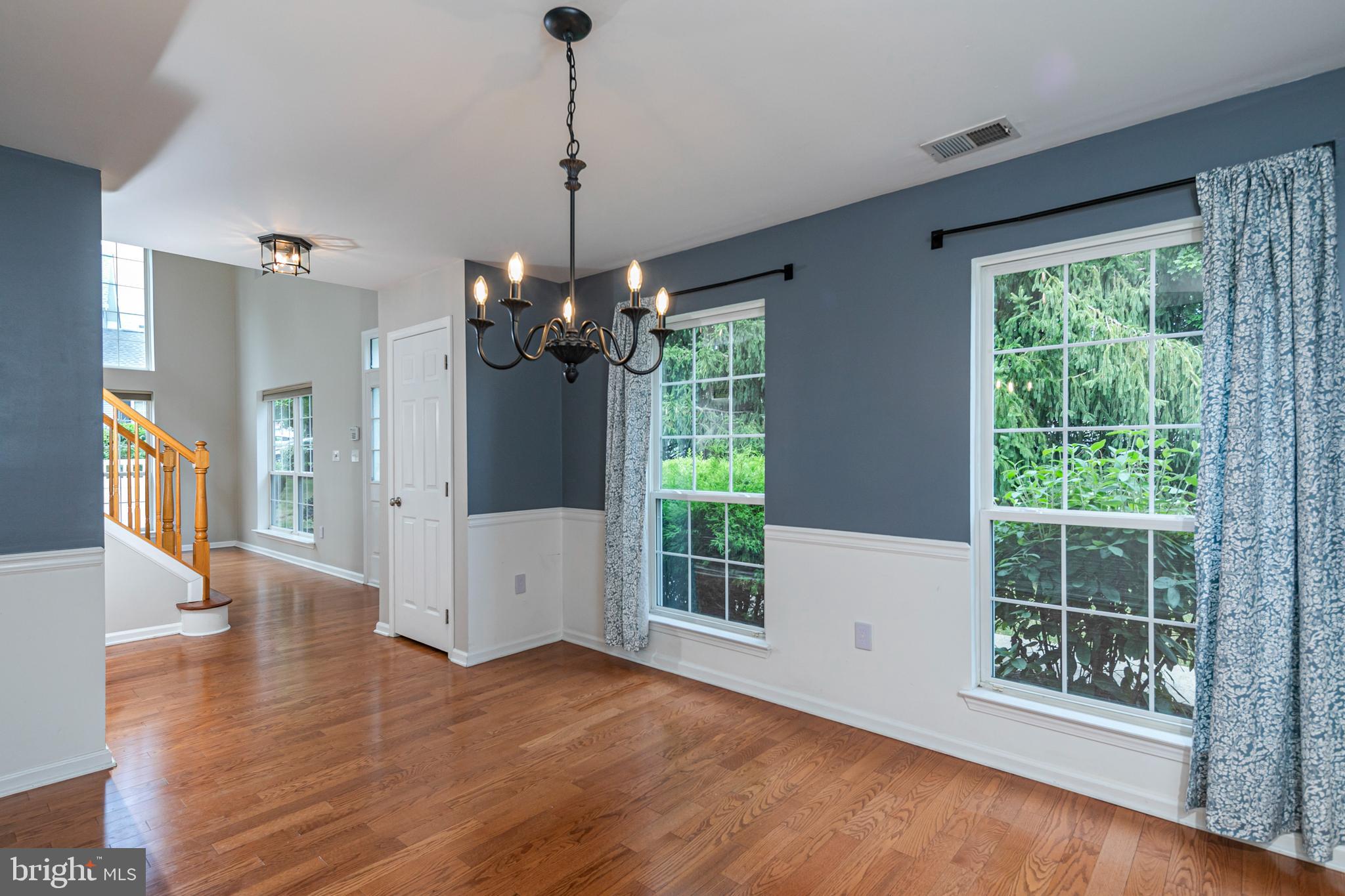 371 Watkins Road Pennington, NJ 08534 - Photo 8 of 42 a view of a big room with wooden floor and windows