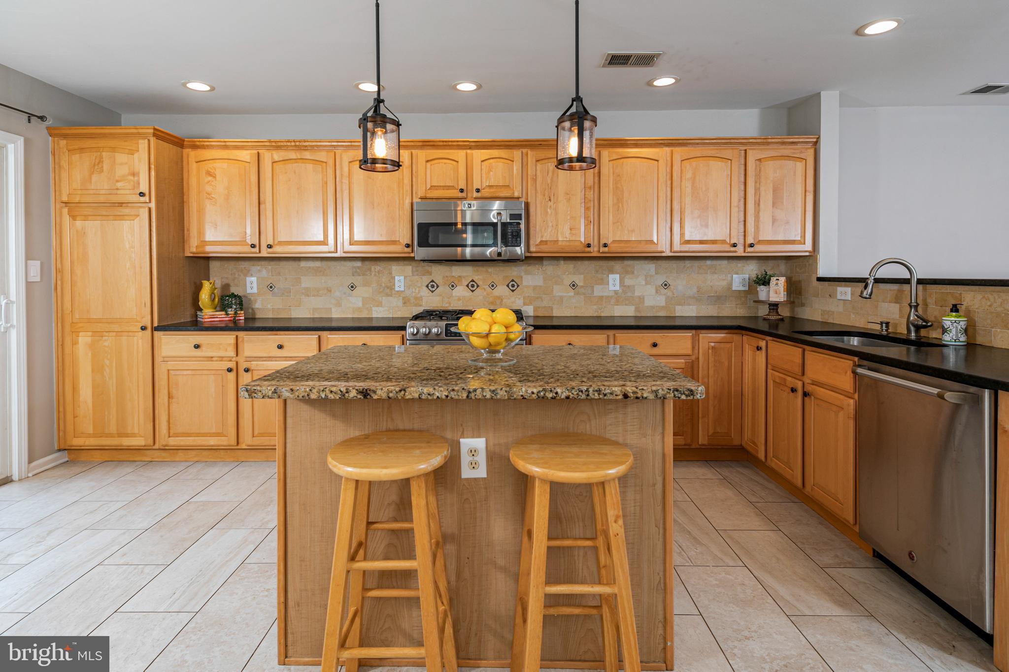 371 Watkins Road Pennington, NJ 08534 - Photo 9 of 42 a kitchen with stainless steel appliances granite countertop a sink a stove and a wooden cabinets