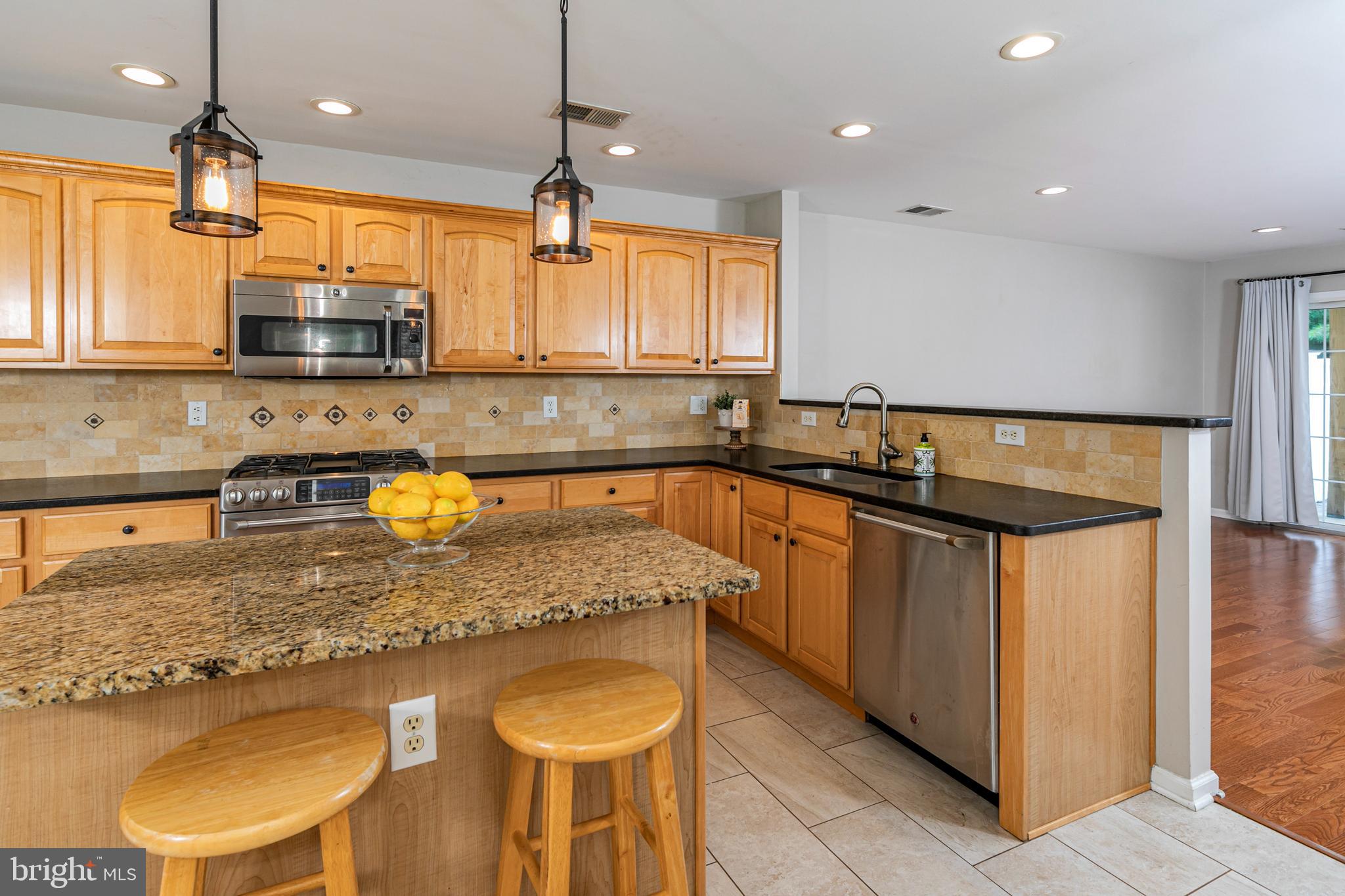 371 Watkins Road Pennington, NJ 08534 - Photo 10 of 42 a kitchen with stainless steel appliances granite countertop a sink a stove and a wooden cabinets