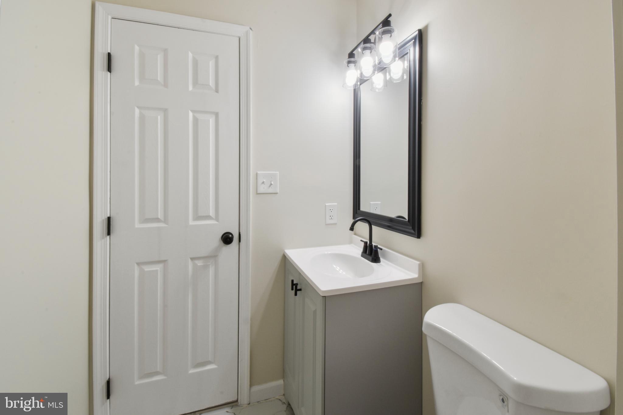 247 Hickory Road Front Royal, VA 22630 - Photo 22 of 46 a bathroom with a toilet sink and mirror