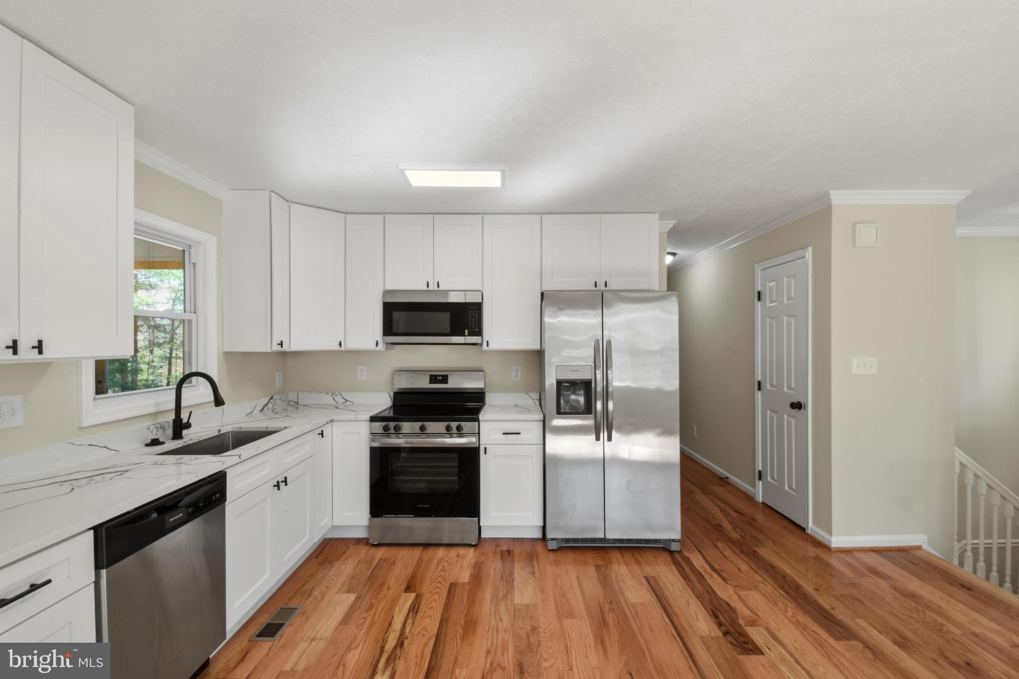 247 Hickory Road Front Royal, VA 22630 - Photo 8 of 46 a kitchen with a sink stainless steel appliances and cabinets