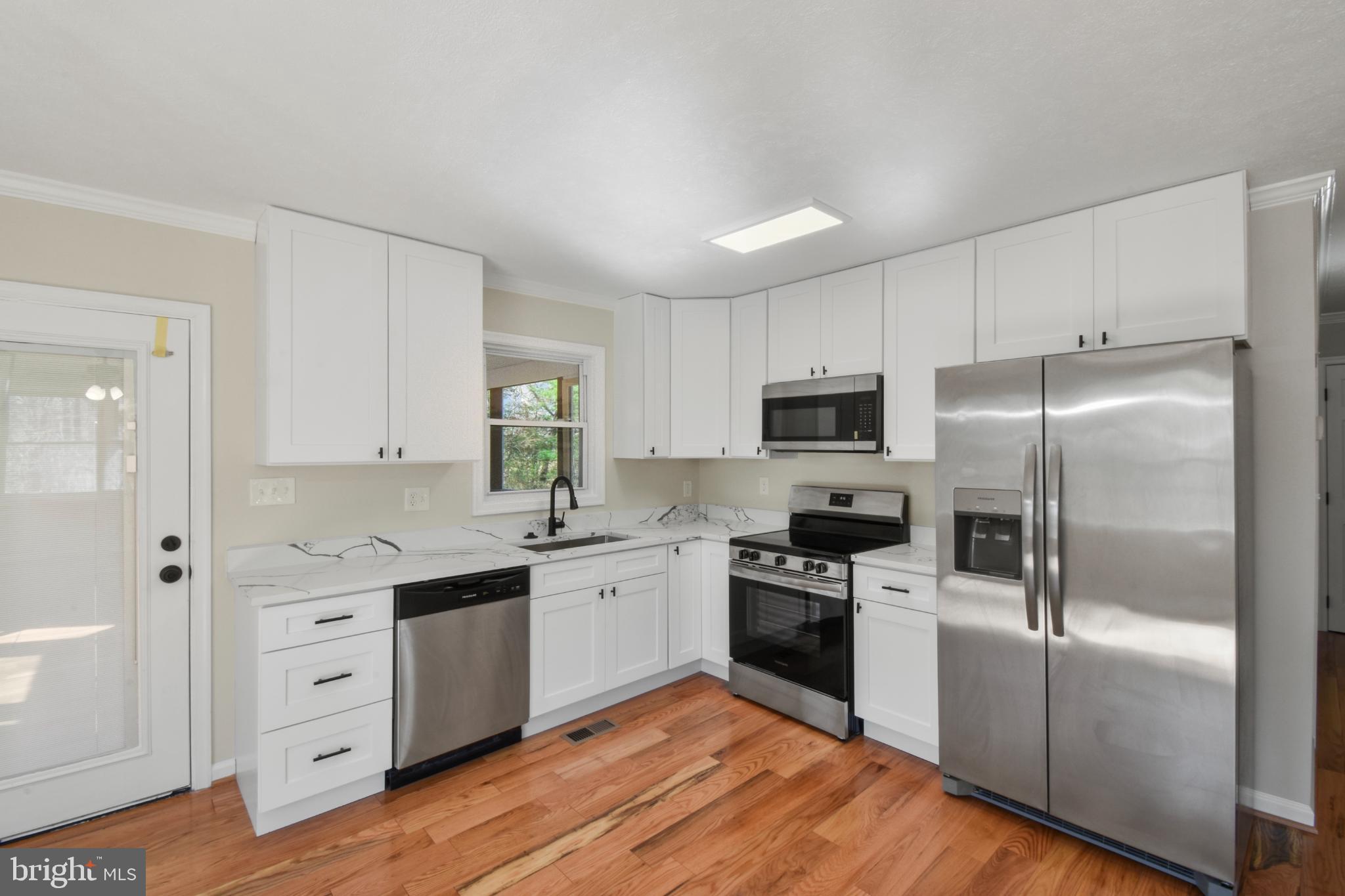 247 Hickory Road Front Royal, VA 22630 - Photo 9 of 46 a kitchen with white cabinets and stainless steel appliances