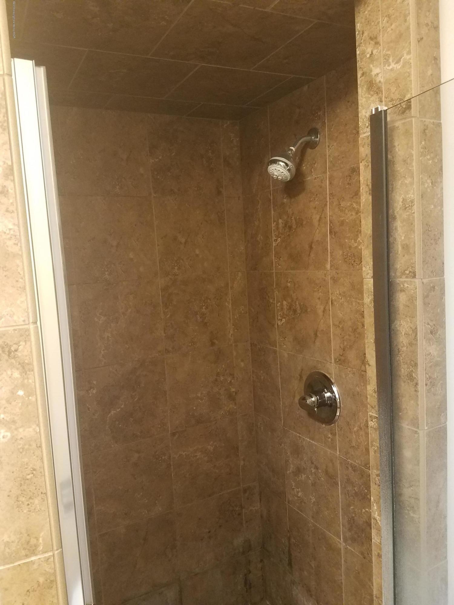 5114 Azalea Avenue Amarillo, TX 79110 - Photo 11 of 13 a bathroom with a shower