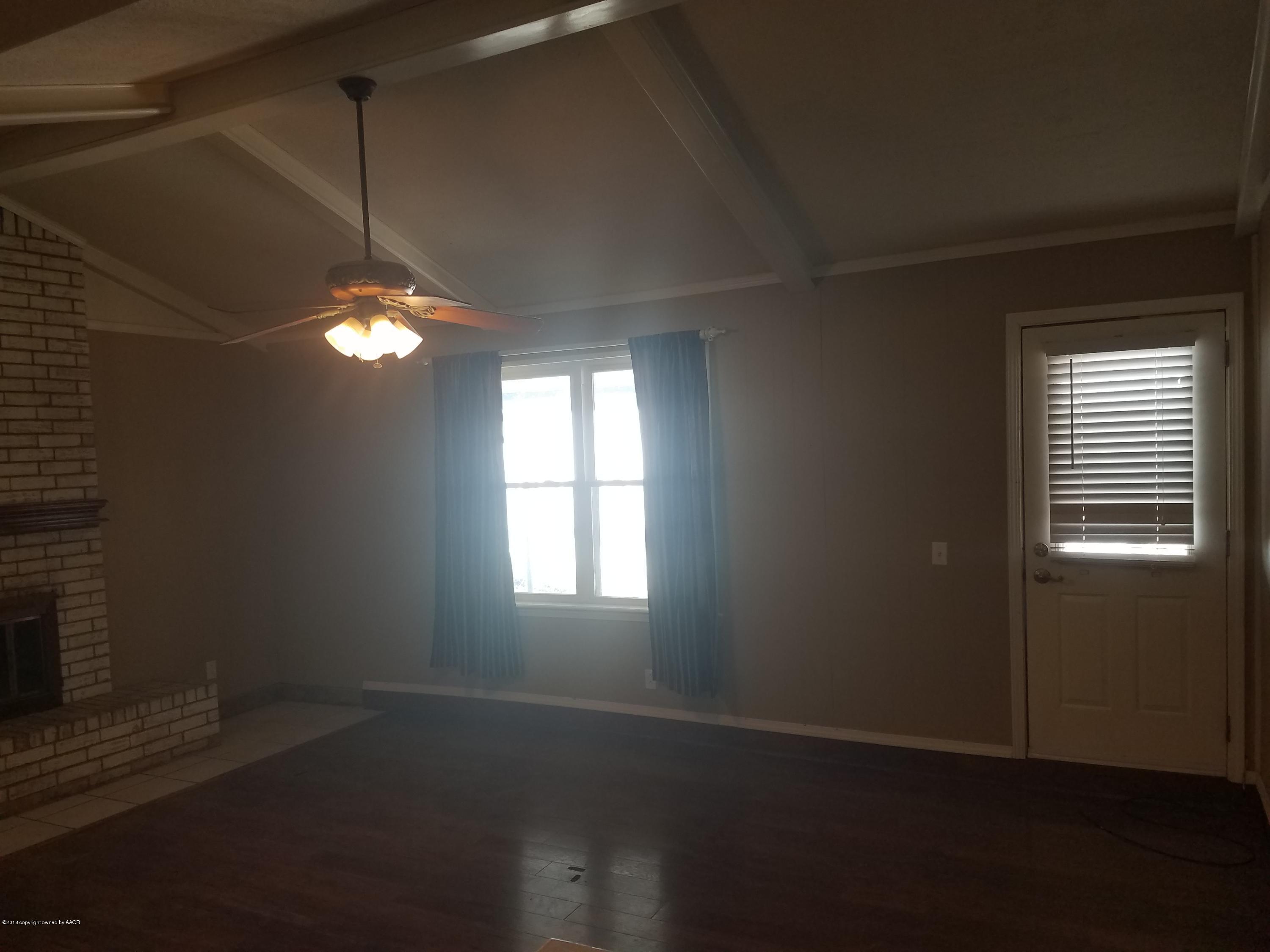 5114 Azalea Avenue Amarillo, TX 79110 - Photo 6 of 13 an empty room with wooden floor and windows