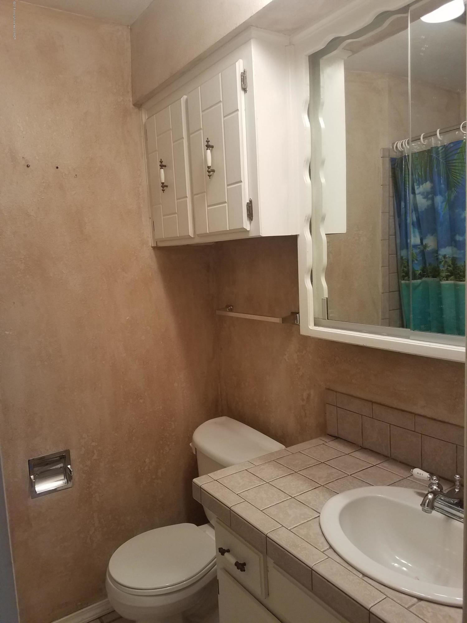 5114 Azalea Avenue Amarillo, TX 79110 - Photo 8 of 13 a bathroom with a sink a toilet and shower