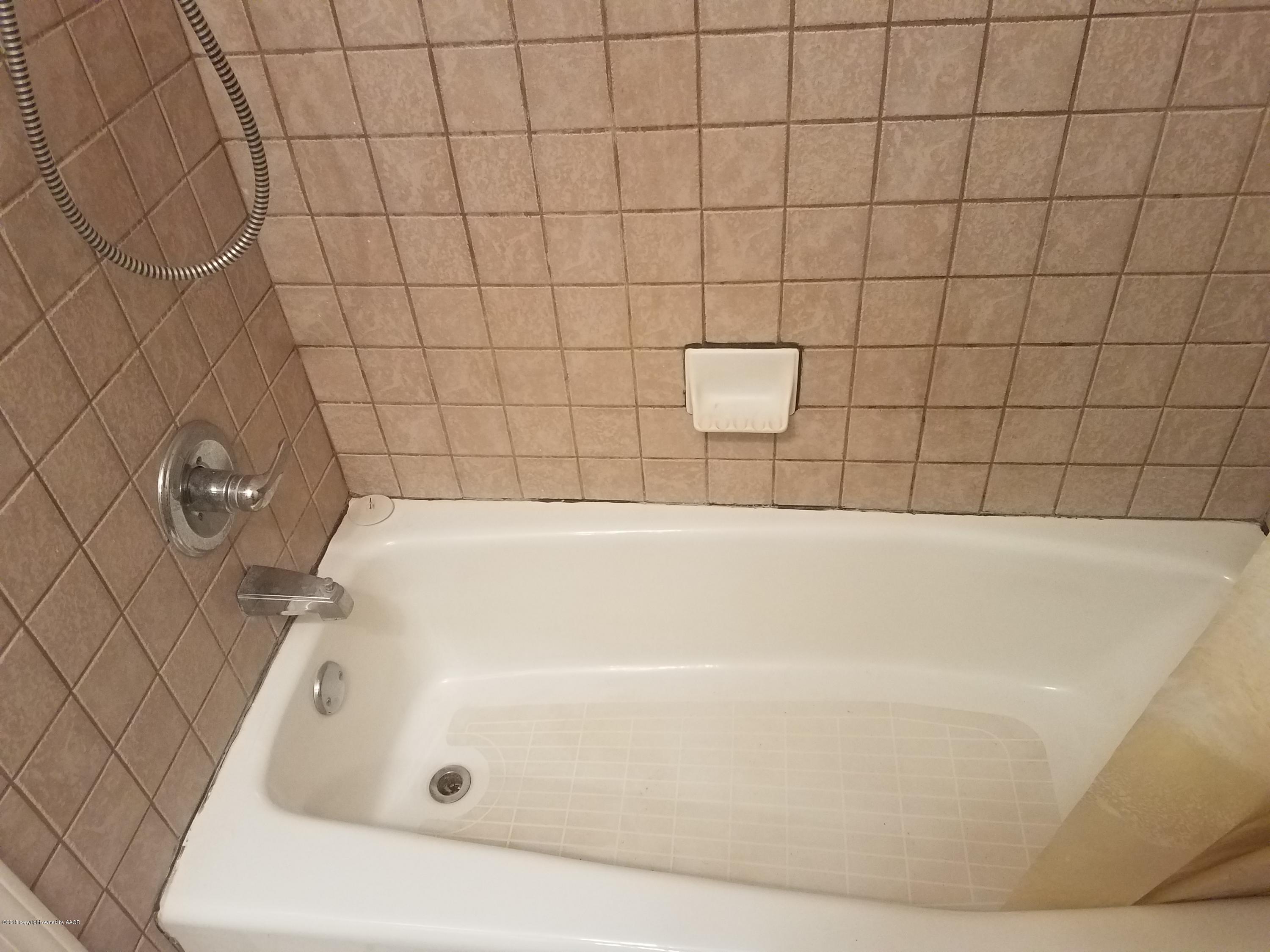 5114 Azalea Avenue Amarillo, TX 79110 - Photo 9 of 13 a bathroom with a bathtub