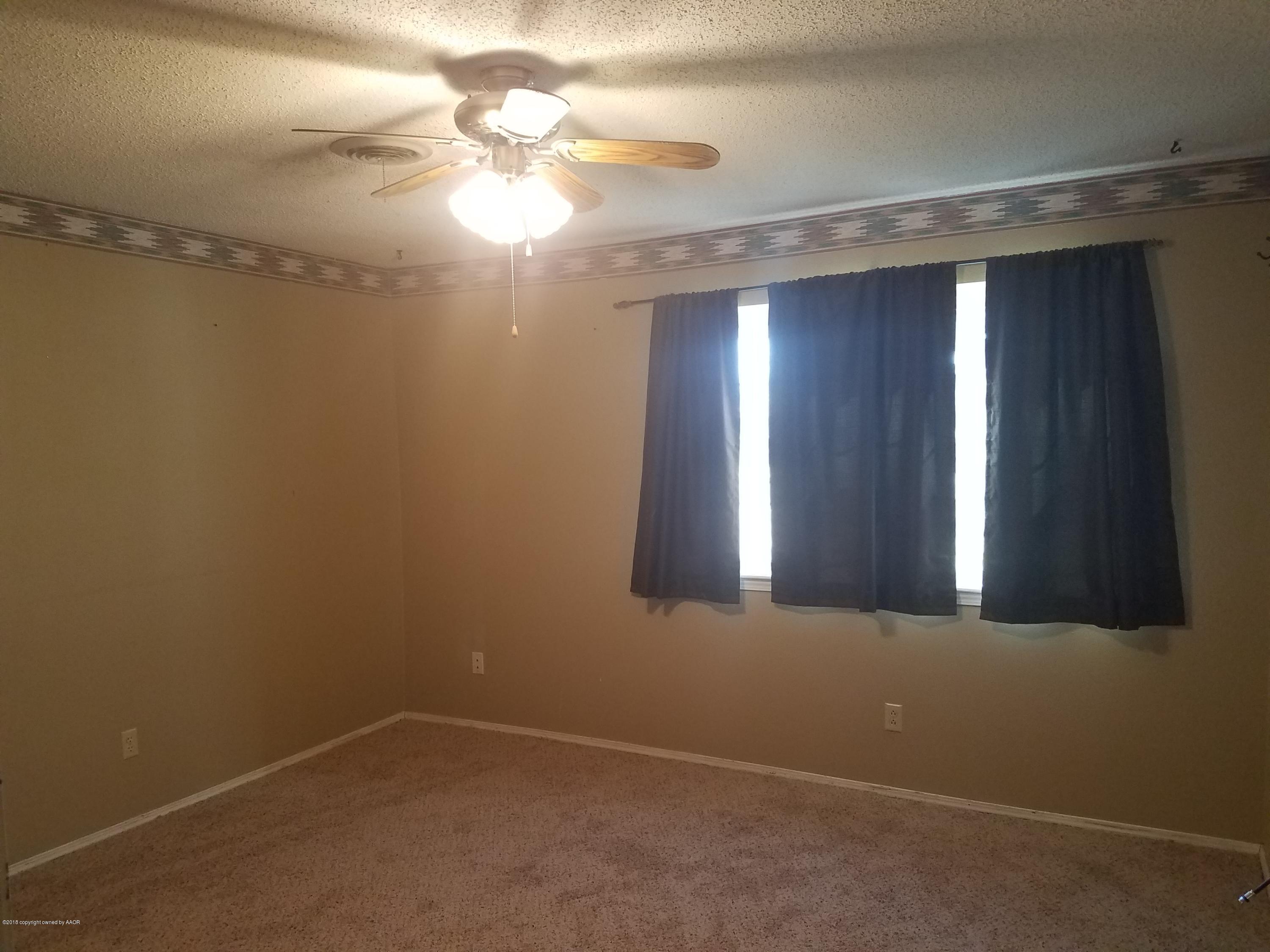 5114 Azalea Avenue Amarillo, TX 79110 - Photo 10 of 13 en empty room with windows and fan