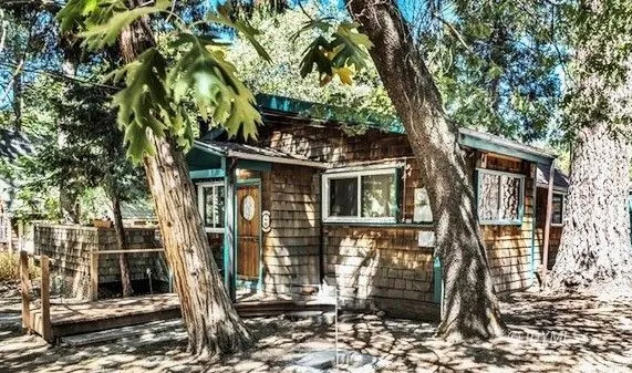 a front view of a house with trees