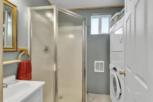 a bedroom with two beds and wooden floor