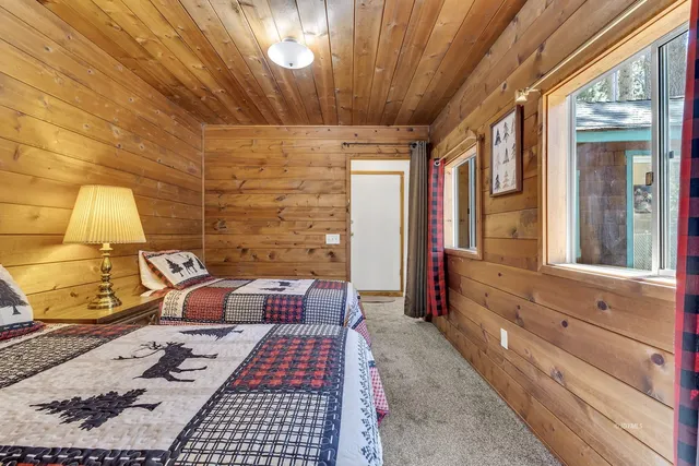 a bedroom with a bed and a large window with outer view