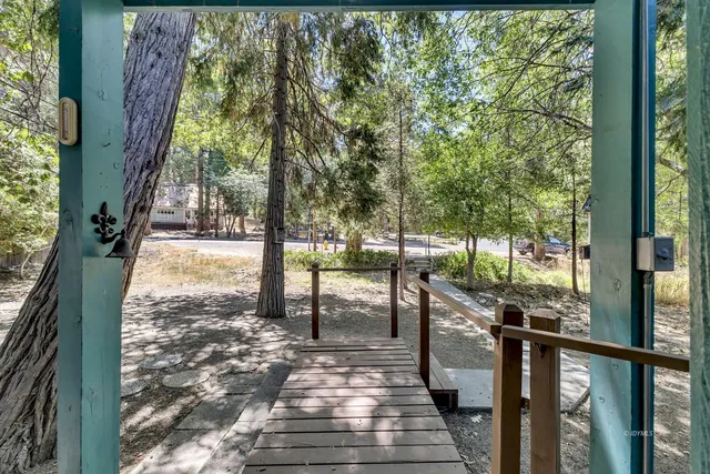 a view of backyard with outdoor seating a patio and plants