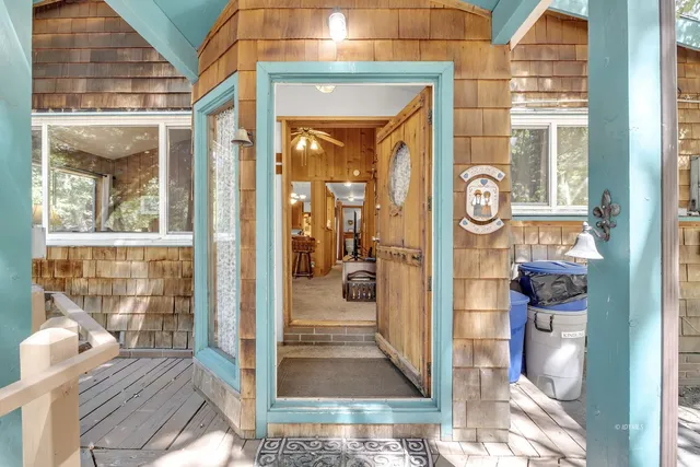 a view of a hallway with wooden floor and furniture