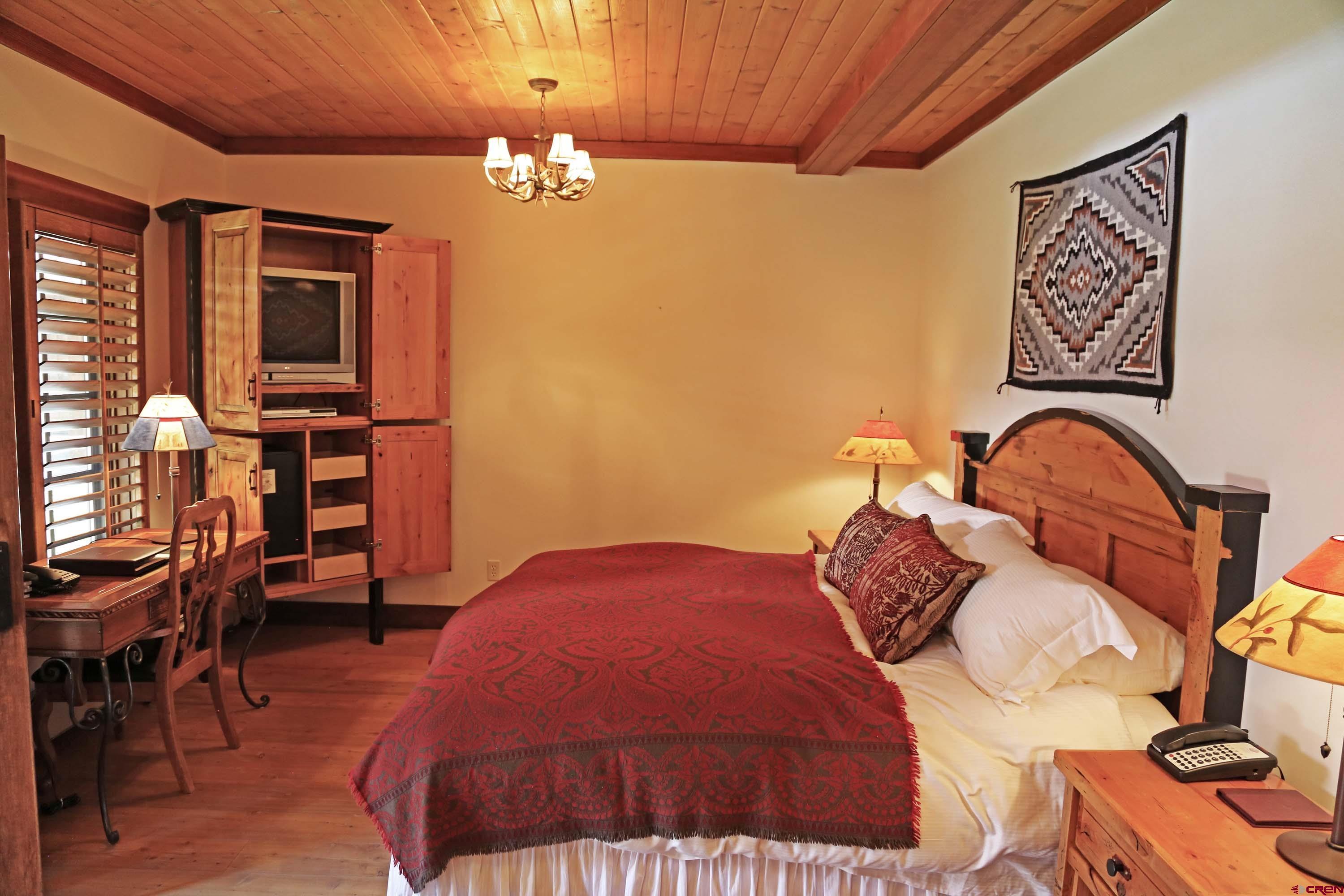 97 Elk Walk Road Montrose, CO 81403 - Photo 20 of 34 a bedroom with a bed and furniture