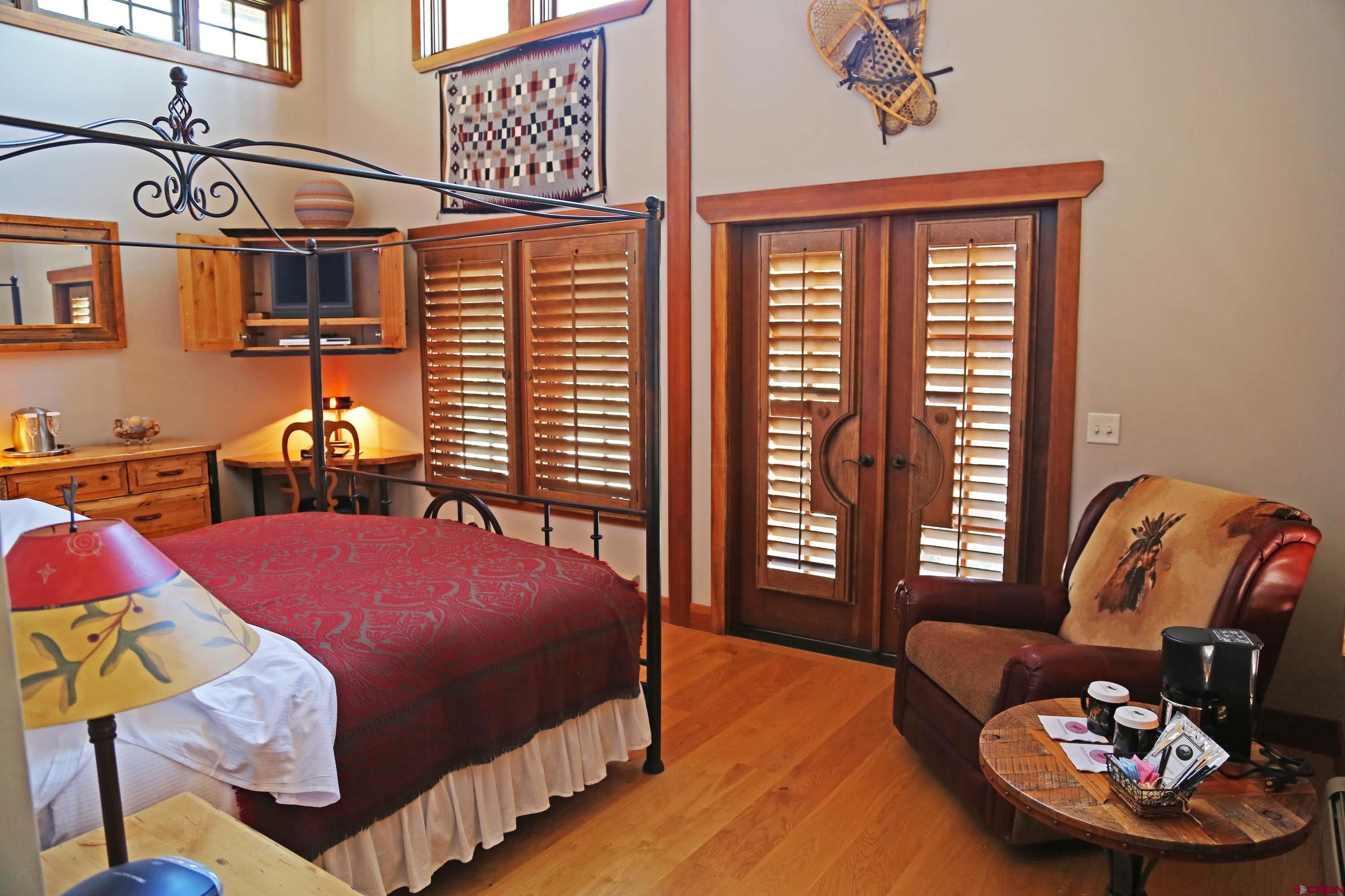 97 Elk Walk Road Montrose, CO 81403 - Photo 21 of 34 a bedroom with furniture and a window
