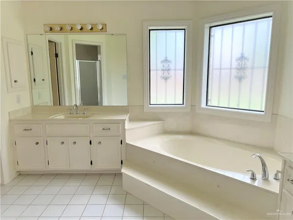 a bathroom with a bathtub sink and a window