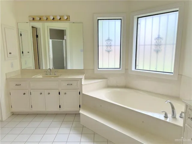 a bathroom with a bathtub sink and a window