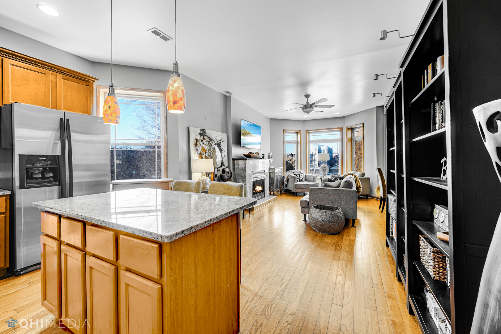 4341 South Prairie Avenue, Unit 2 Chicago, IL 60653 - Photo 3 of 11 a kitchen with stainless steel appliances granite countertop counter space and wooden floors