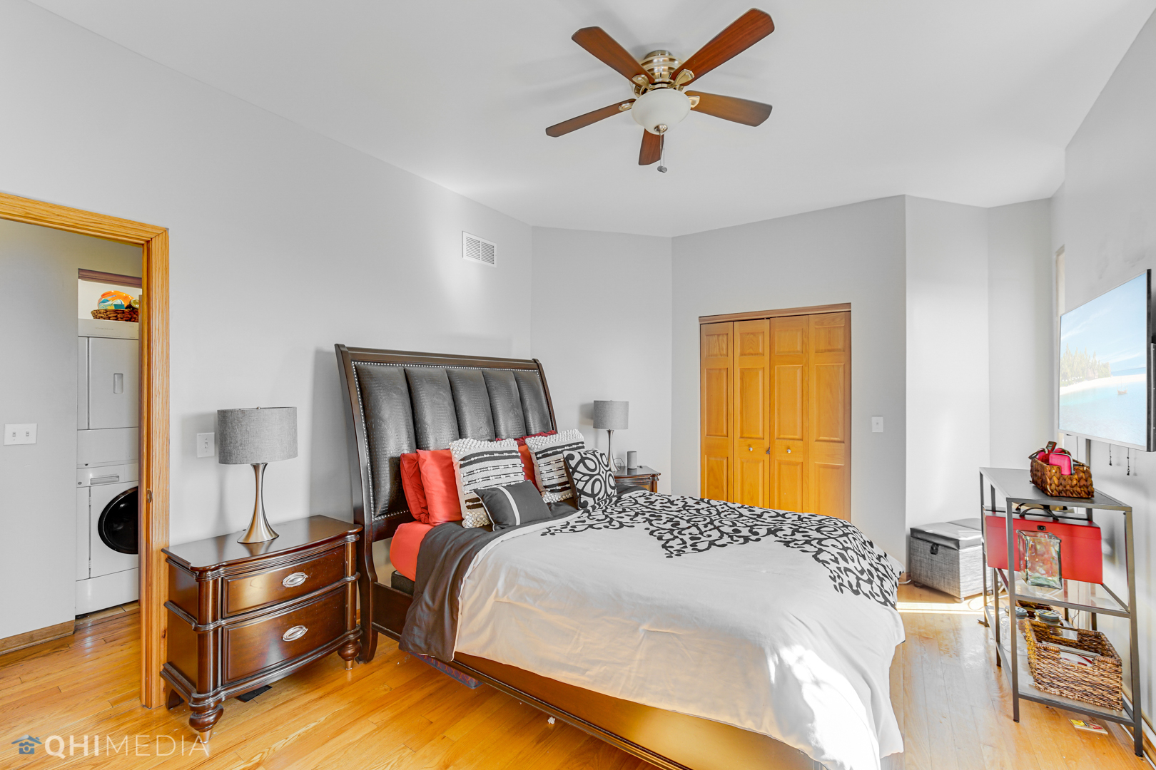 4341 South Prairie Avenue, Unit 2 Chicago, IL 60653 - Photo 8 of 11 a bedroom with a bed and a chandelier