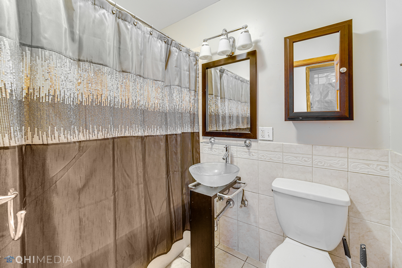 4341 South Prairie Avenue, Unit 2 Chicago, IL 60653 - Photo 10 of 11 a bathroom with a toilet a sink and a shower curtain