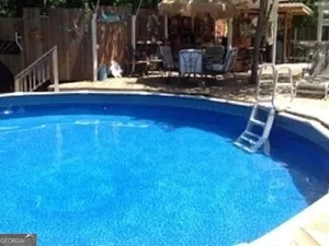 a view of a house with a backyard
