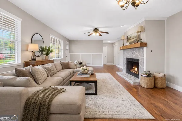 a living room with furniture and a fireplace