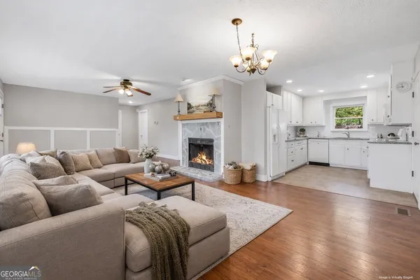 a living room with furniture and a fireplace